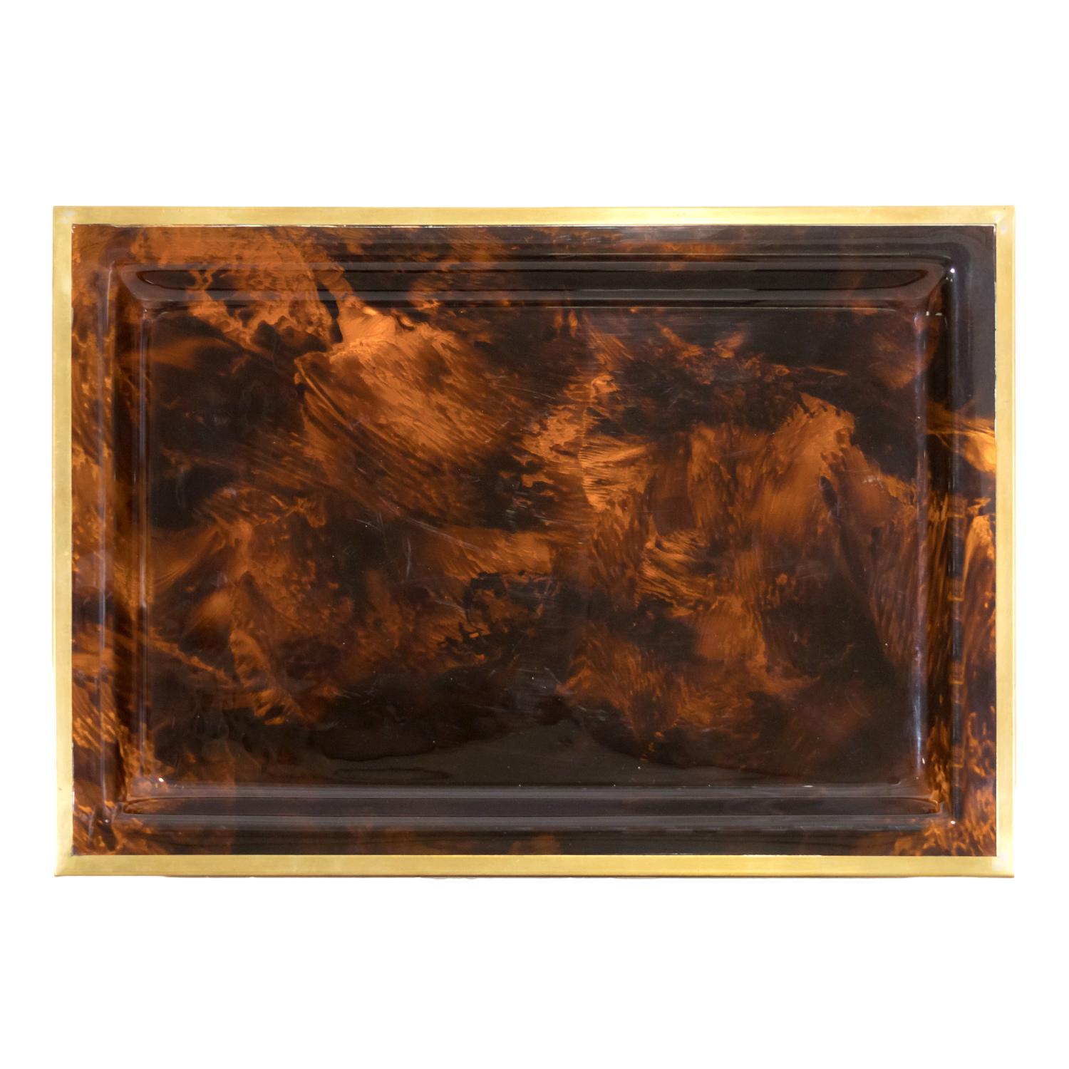 A fabulous 20th century vintage faux tortoiseshell rectangular shaped lucite serving tray or vide-poche with wrapped brass edge made in Italy by Christian Dior Home, circa 1970s. Serve up cocktails in style anytime with this iconic mid-century