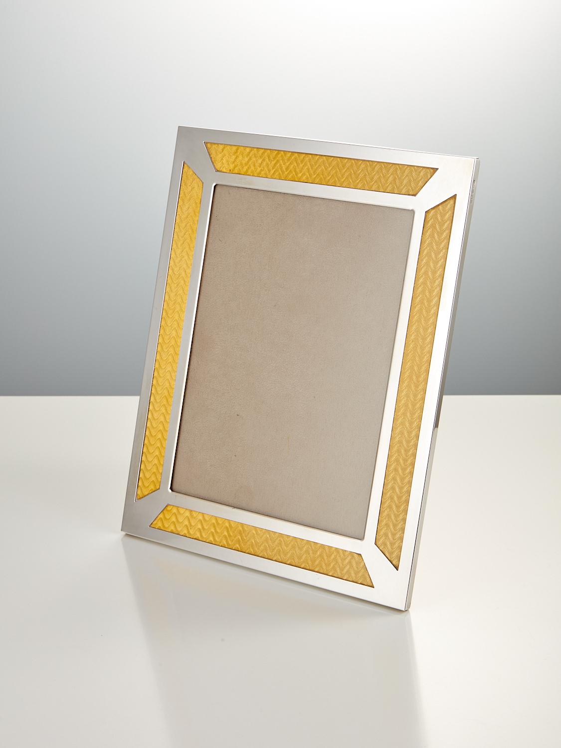 A Late 20th Century English Sterling Silver vintage photo Frame with foil enamel decoration, Date 1963-64, London.

This vintage silver frame is excellent quality with full hallmark & makers initials GK & CK Kitney & Co.
The foil enamel decoration