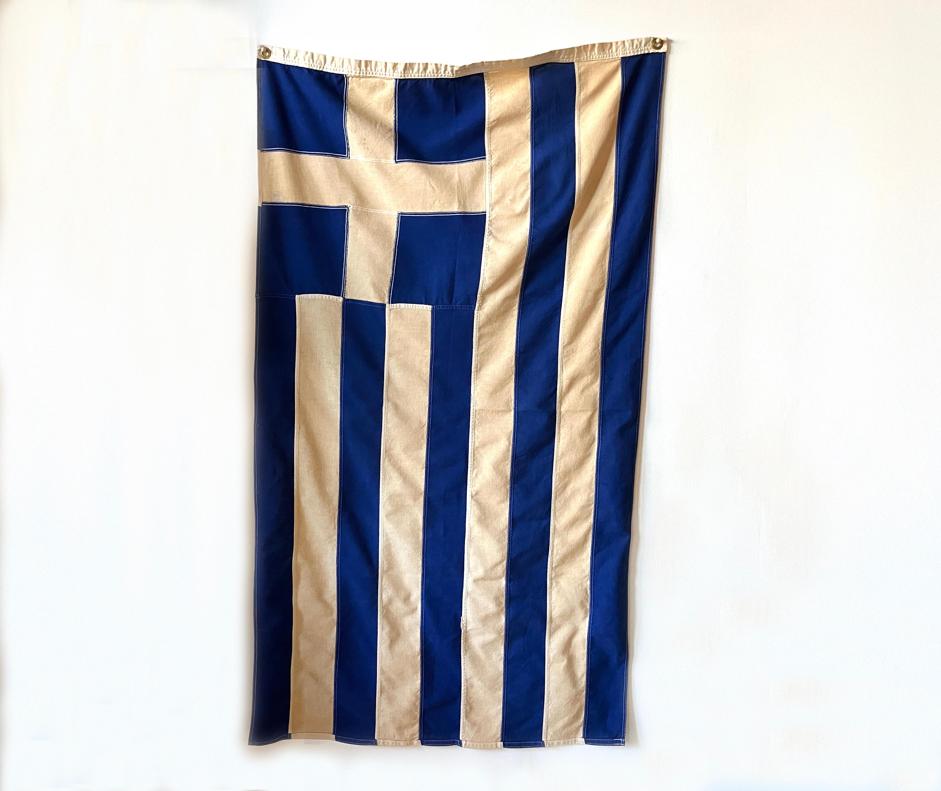 An original 100% cotton bunting Greek flag with brass grommets, made by Defiance in Verona, New Jersey. Heavy woven fabric with bold blue color.

Measures exactly 34