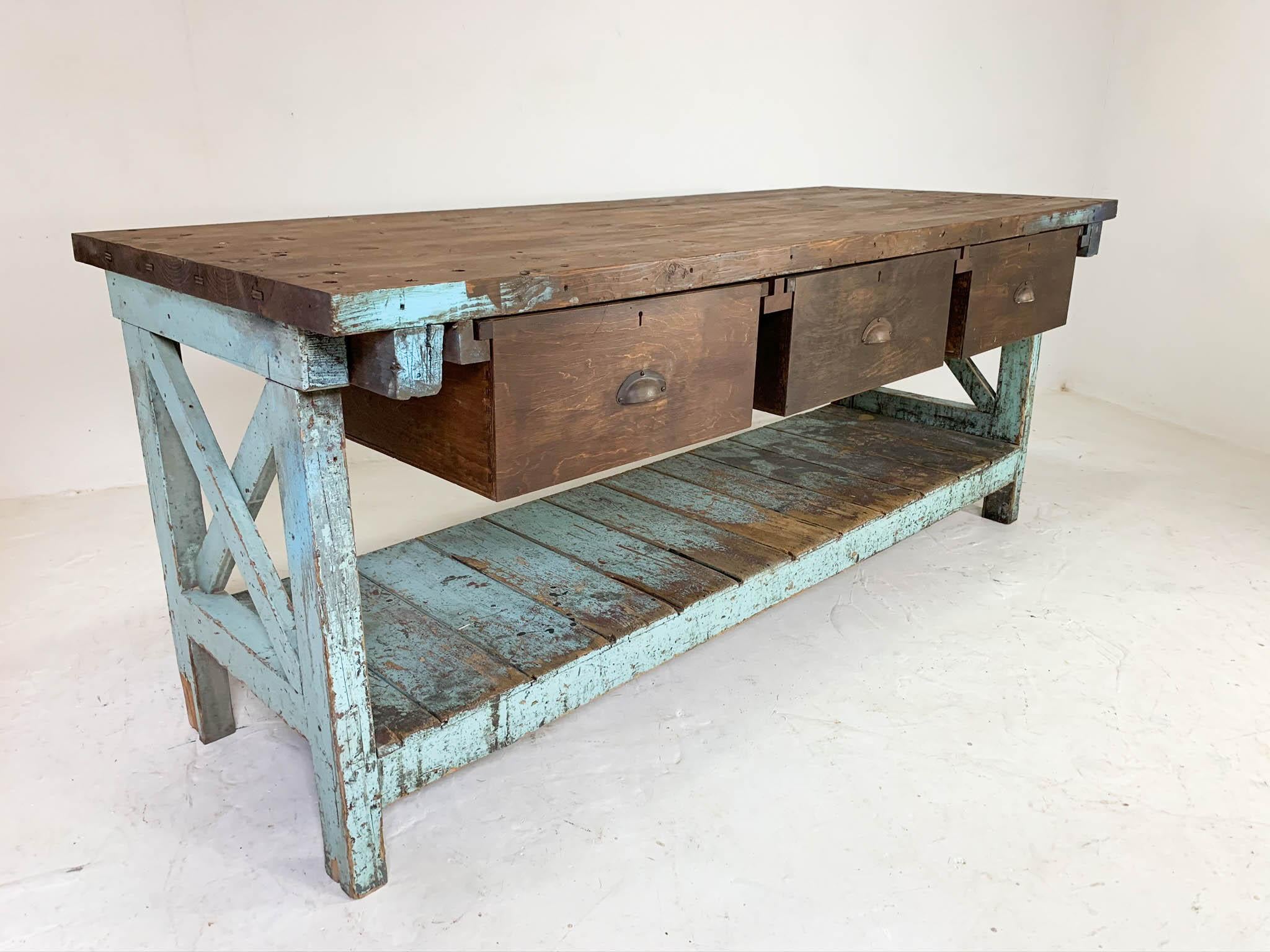 Vintage English workbench dating from the 1950s, sourced from a steel factory in Sheffield. It has all original parts: three large deep drawers with cup handles, potting board shelf below which provides great storage for larger items and original