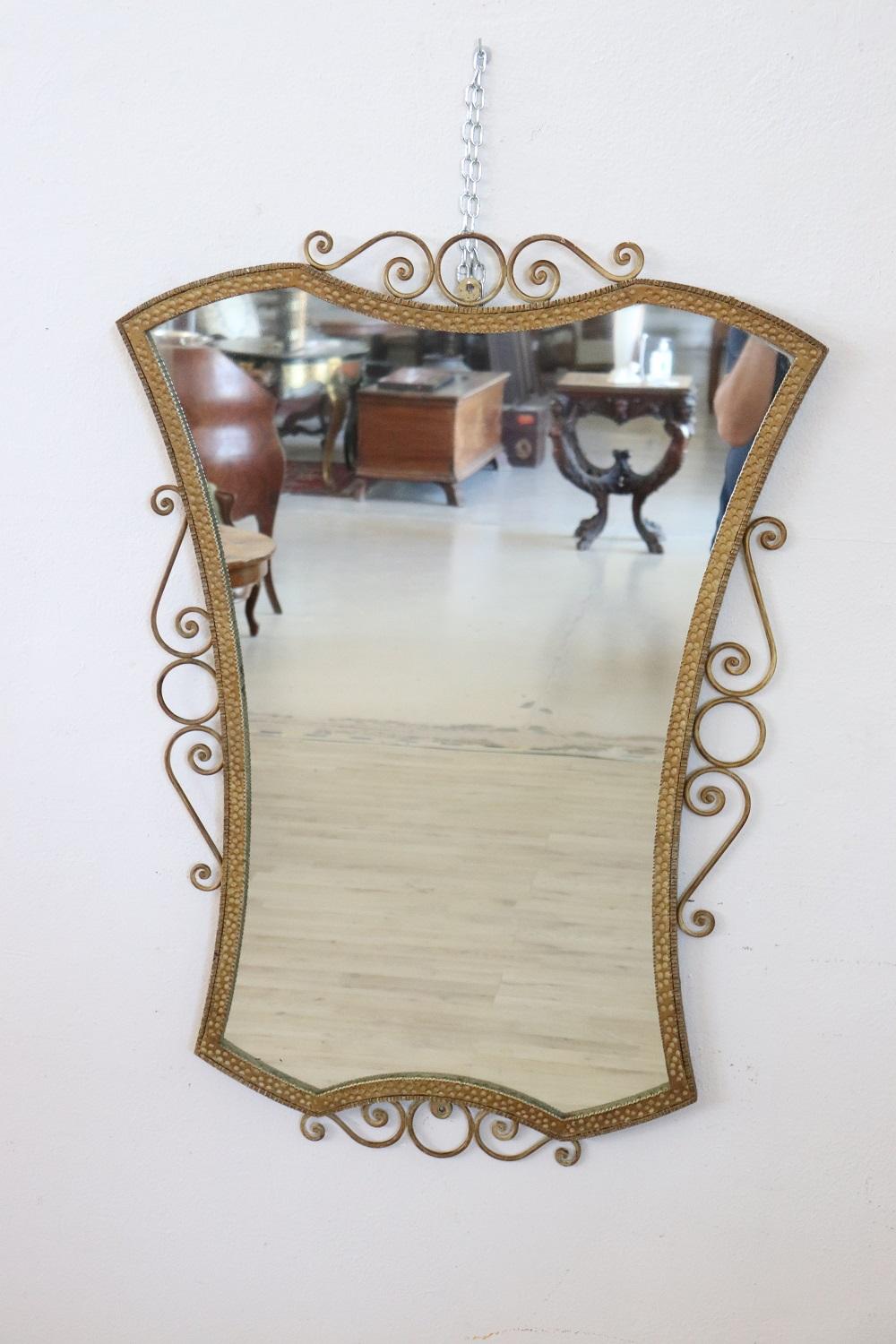Lovely 20th century Italian vintage golden iron wall mirror 1950s with refined decoration. Perfect conditions.