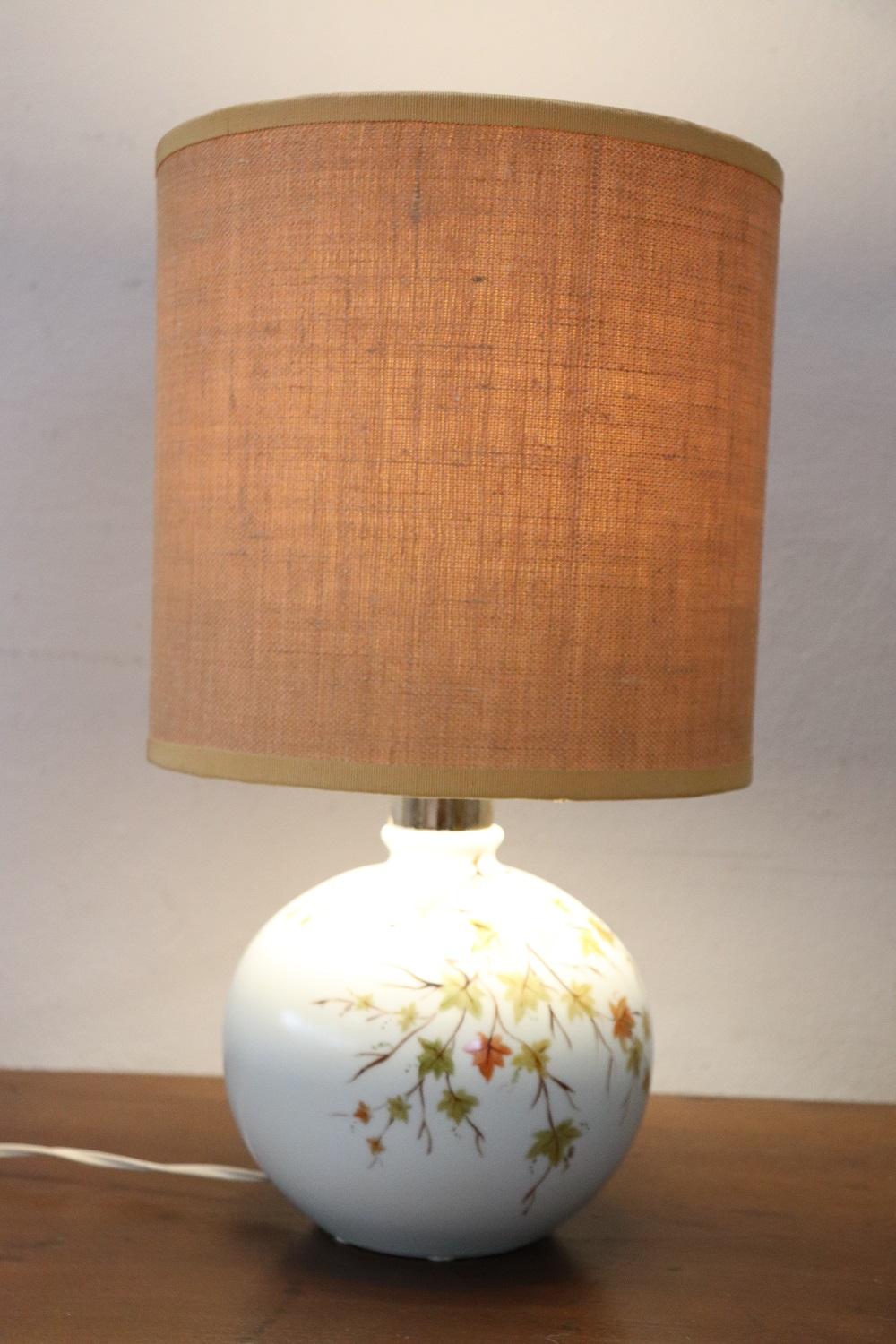 Beautiful table lamp vintage Italian manufacture. Beautiful floral hand painted decoration. Small defect in the lampshade, see photos.