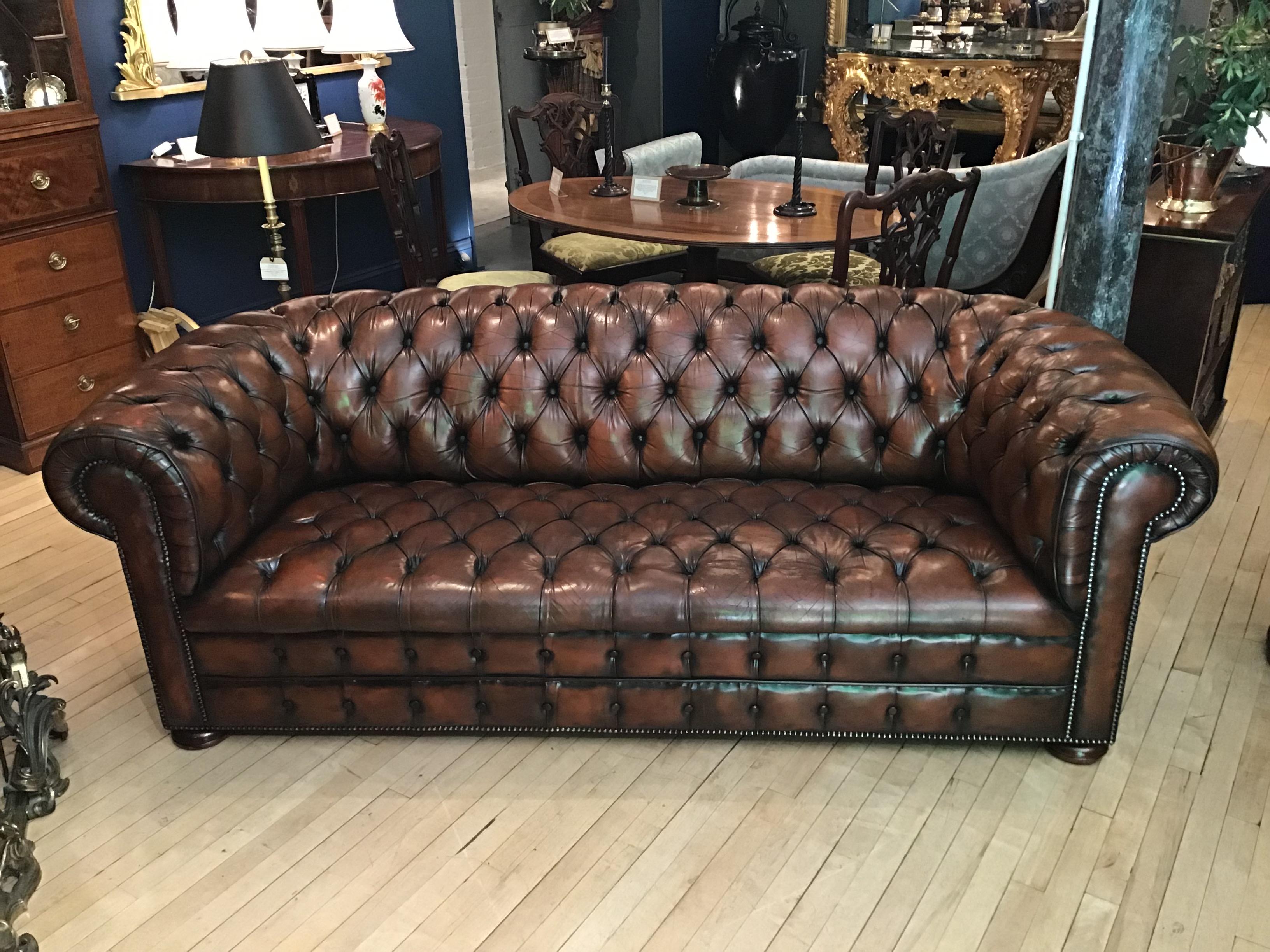 A super example of a mid-20th century brown leather Chesterfield sofa with buttoned seat and back.

The buttoned seat examples being rarer, more desirable and aesthetically pleasing than those with cushions.
Good chesterfields from this period