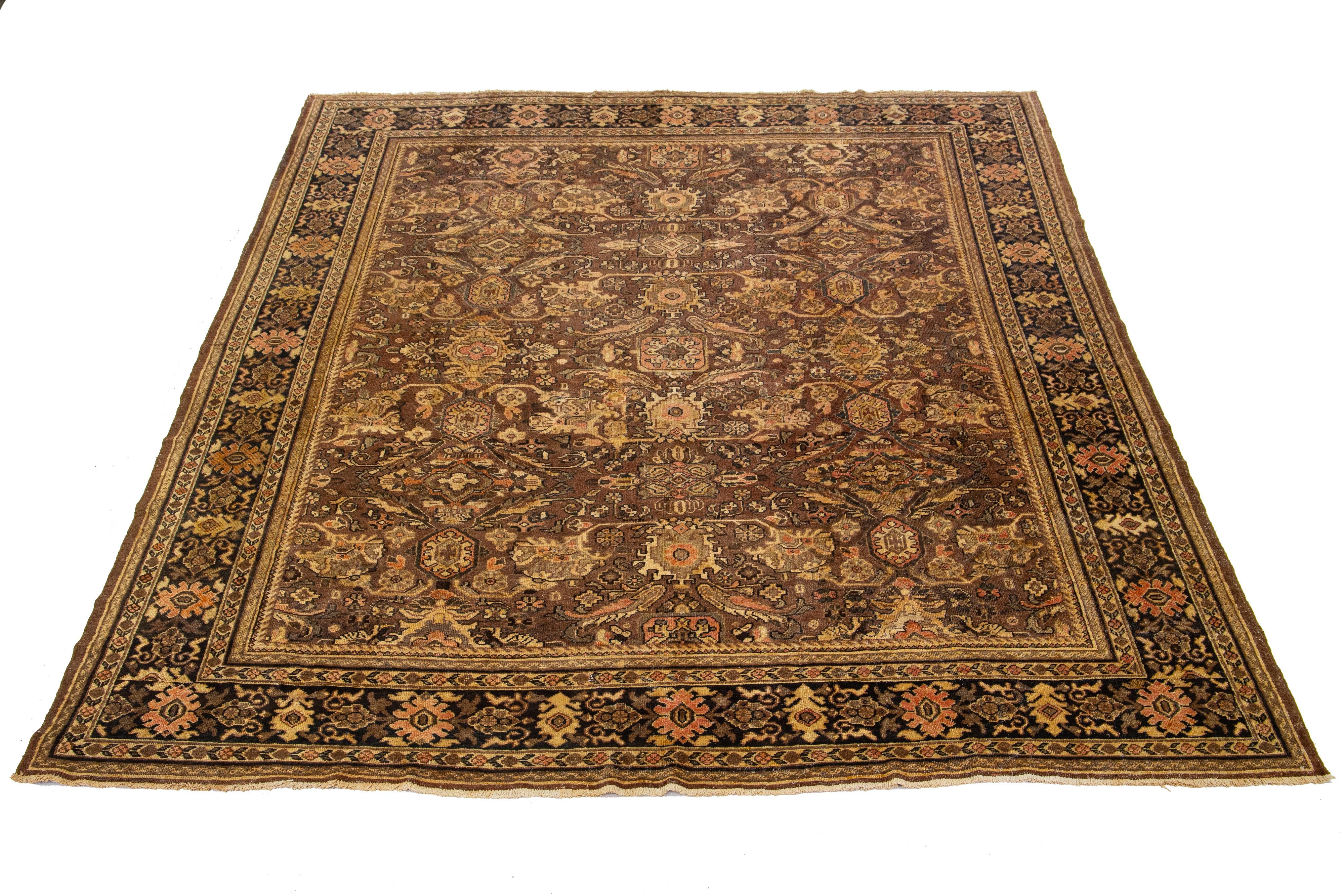 Beautiful Vintage Mahal hand-knotted wool rug with a brown color field. This Persian rug has a Classic blue, rust, and brown allover floral design.

This rug measures 9' x 11'9