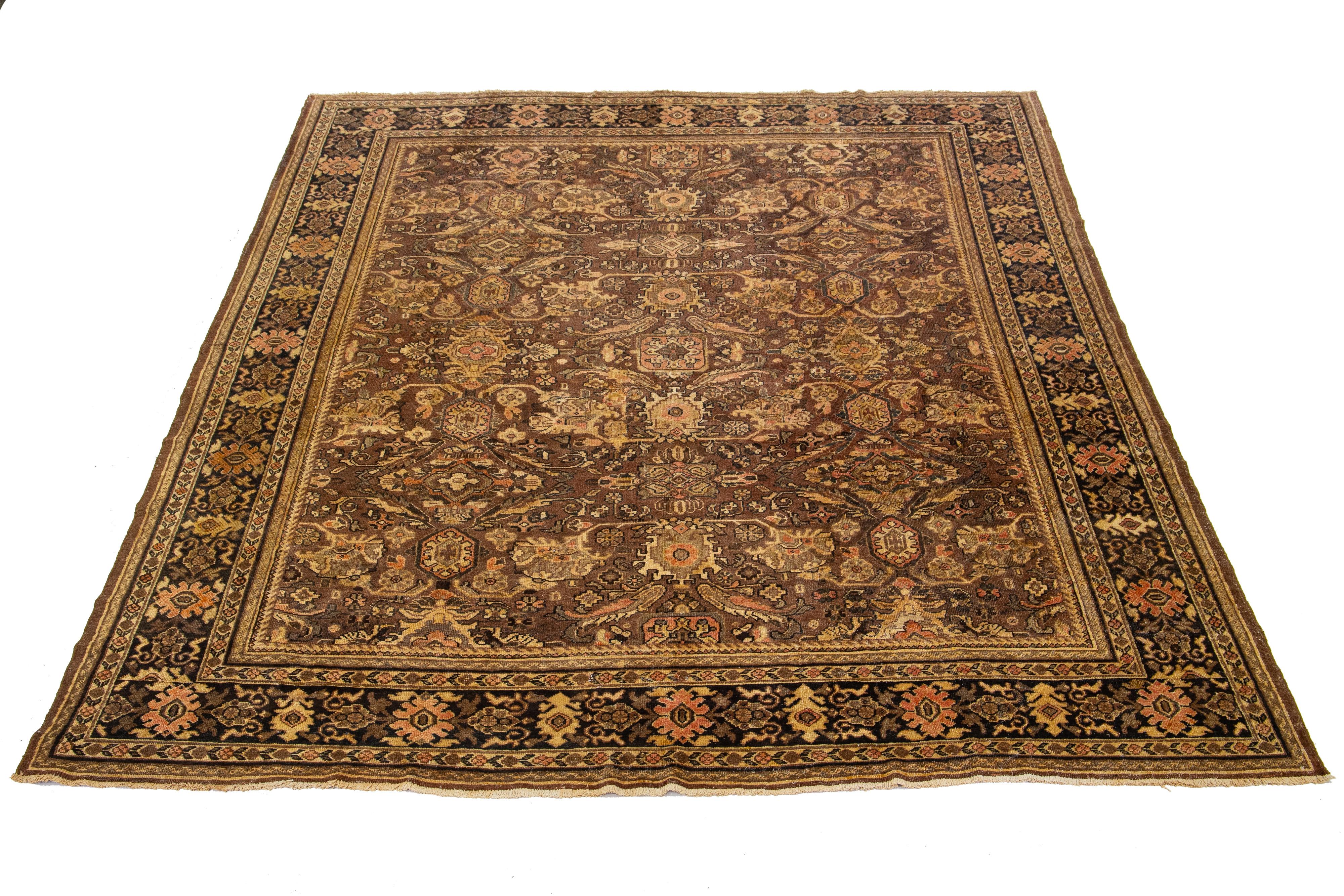 Bellissimo tappeto vintage Mahal in lana annodata a mano con campo marrone. Questo tappeto persiano presenta un disegno floreale classico blu, ruggine e marrone allover.

Questo tappeto misura 9' x 11'9