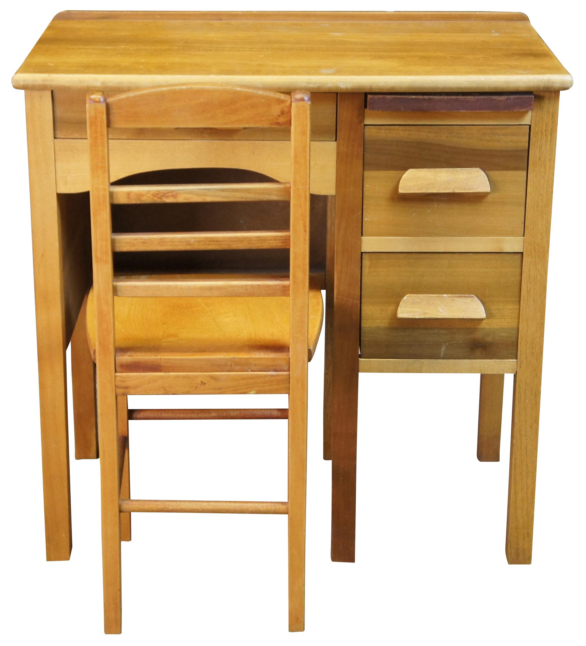 Mid 20th century child's size school desk and chair. Made from maple. Includes 3 drawers and pullout writing surface.

Measures: desk 27