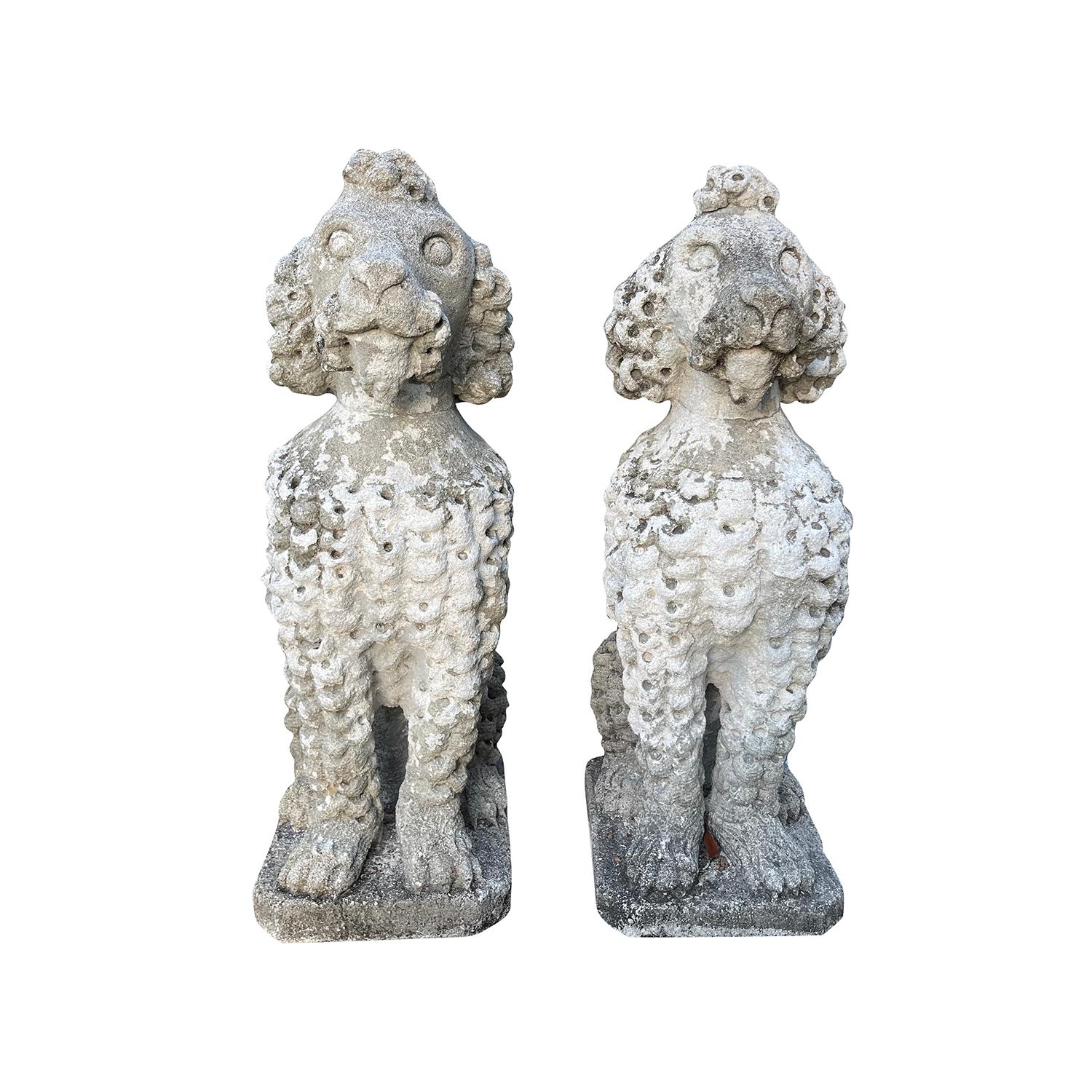 A pair of vintage French poodle garden statues in a seated and attentive position, in good condition. The garden ornaments are hand carved limestone and have a beautiful natural patina. These intricately carved garden dog statuettes can be also used
