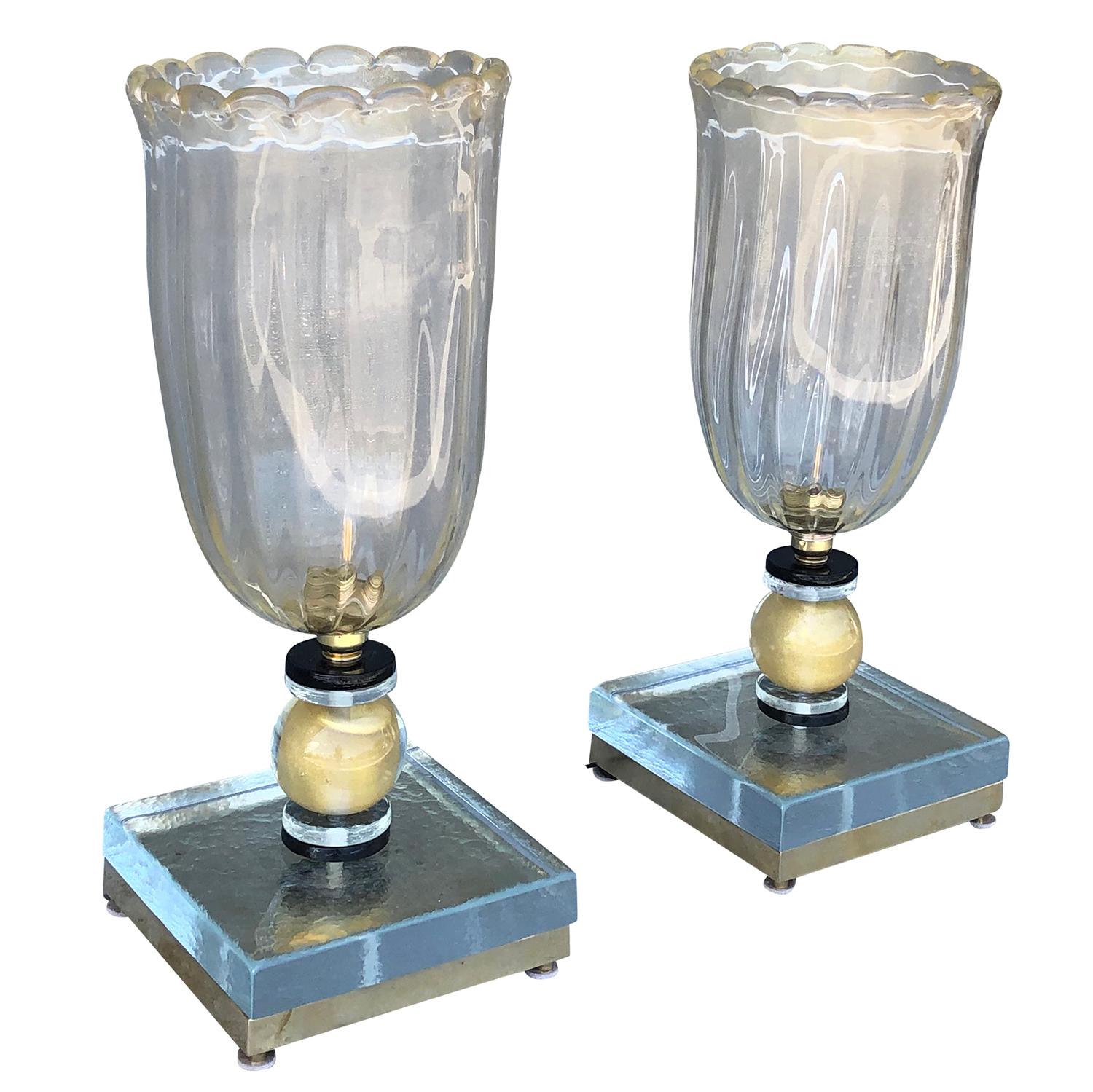 An Italian pair of vintage Mid-Century Modern table lamps. Both lamps are made of lightly frosted, hand-blown Murano glass, one light socket. These elegant, authentic modern Mid-Century table lamps can be used in an office, as bedside lamps, or in a