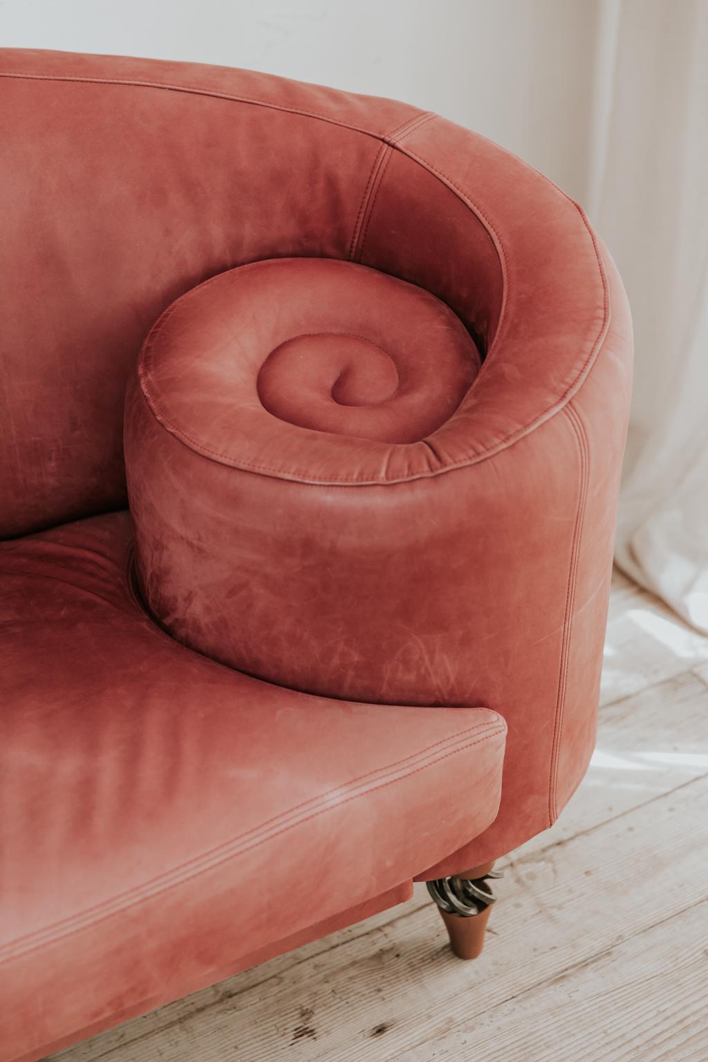 This leather sofa was made by Maroeska Metz, Dutch designer in the 1990s,
color is a sublime raspberry red, Maroeska always added a curl to every piece she created.