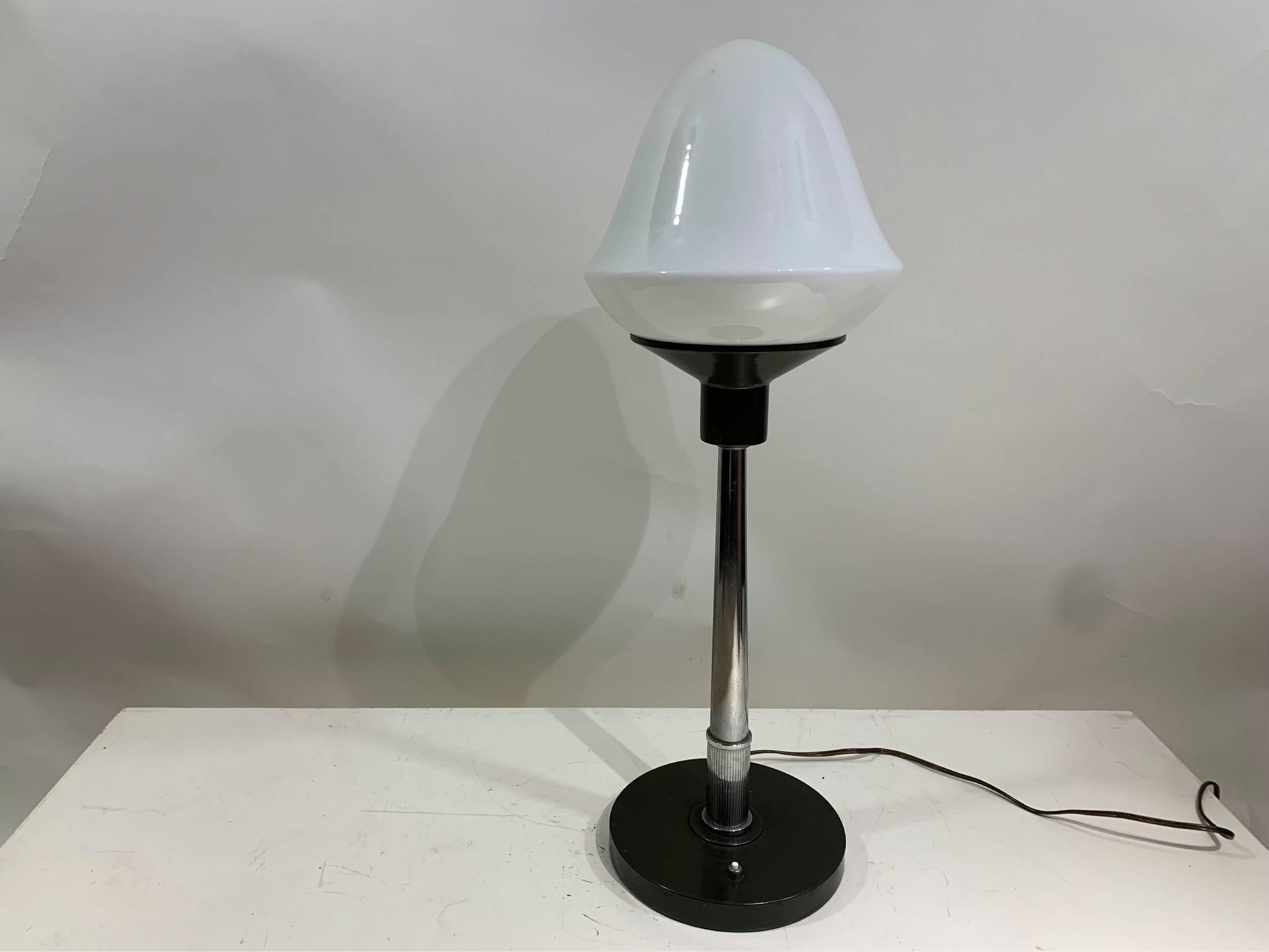 Discover the elegance and versatility of tjis stunning large table lamp, which stands impressively at 73 cm in height. This exquisite piece features a striking black base that supports a beautiful lamp shade crafted from milk glass. The design is