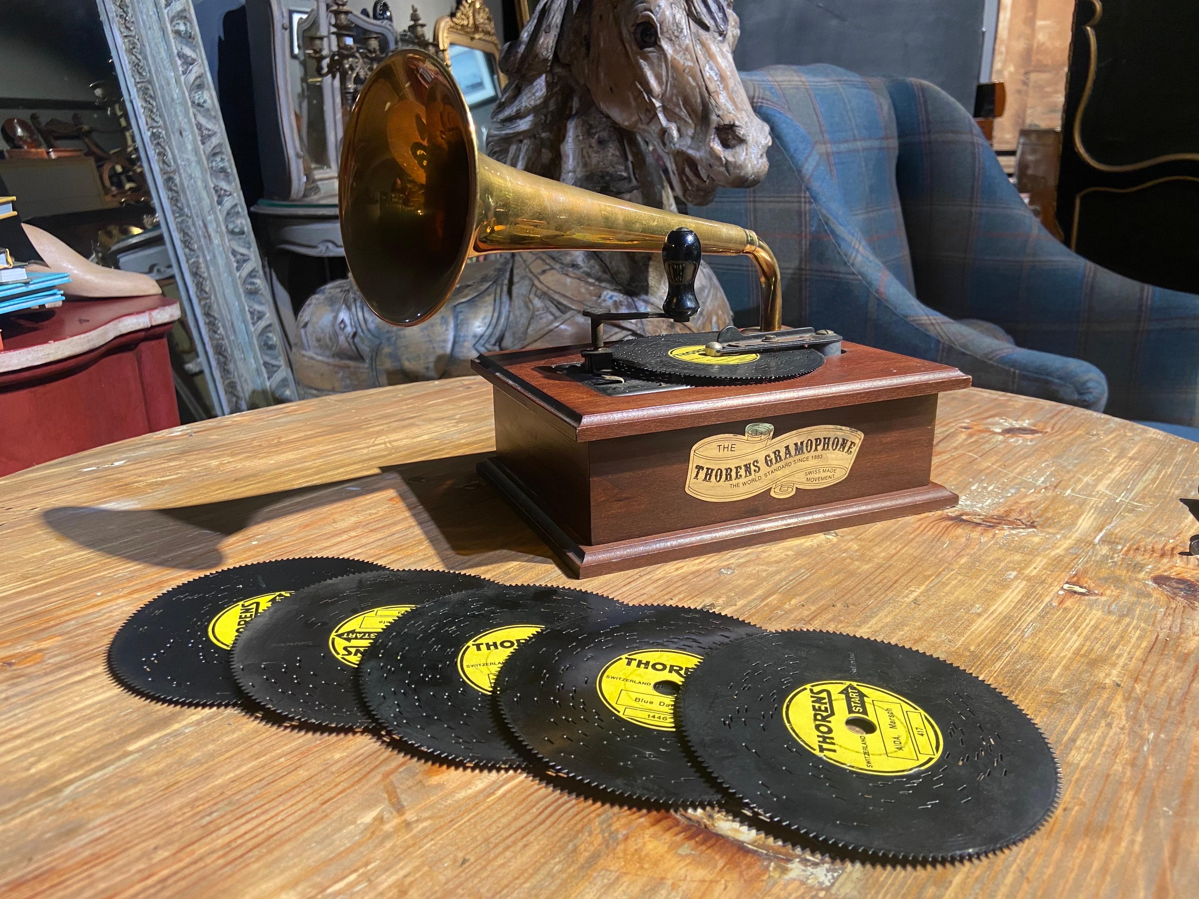 Here we present a vintage Thorens Gramophone AD-30 disc player/ music box, Thorens model #755, circa 1975. The nostalgic solid wood cabinet was hand crafted by Thorens and features a mahogany finish, as well as a removable solid brass horn. The back