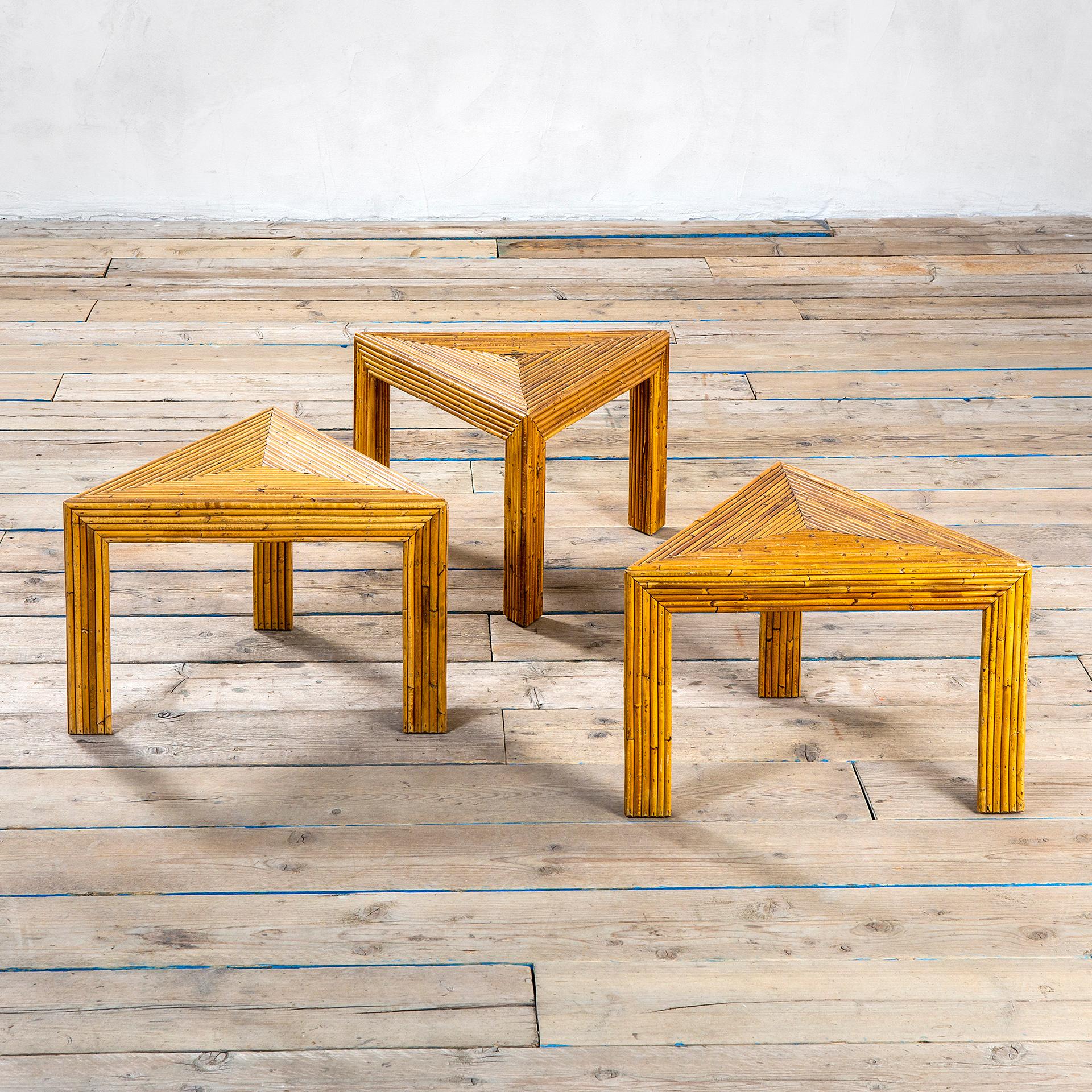 Set of three low table in triangular shap in wicker and bamboo by Vivai del Sud and designed in '60s. 
The tables can be set as a unique table (in different shapes, some suggestions in our photos) or they can be set separated in the room. These are