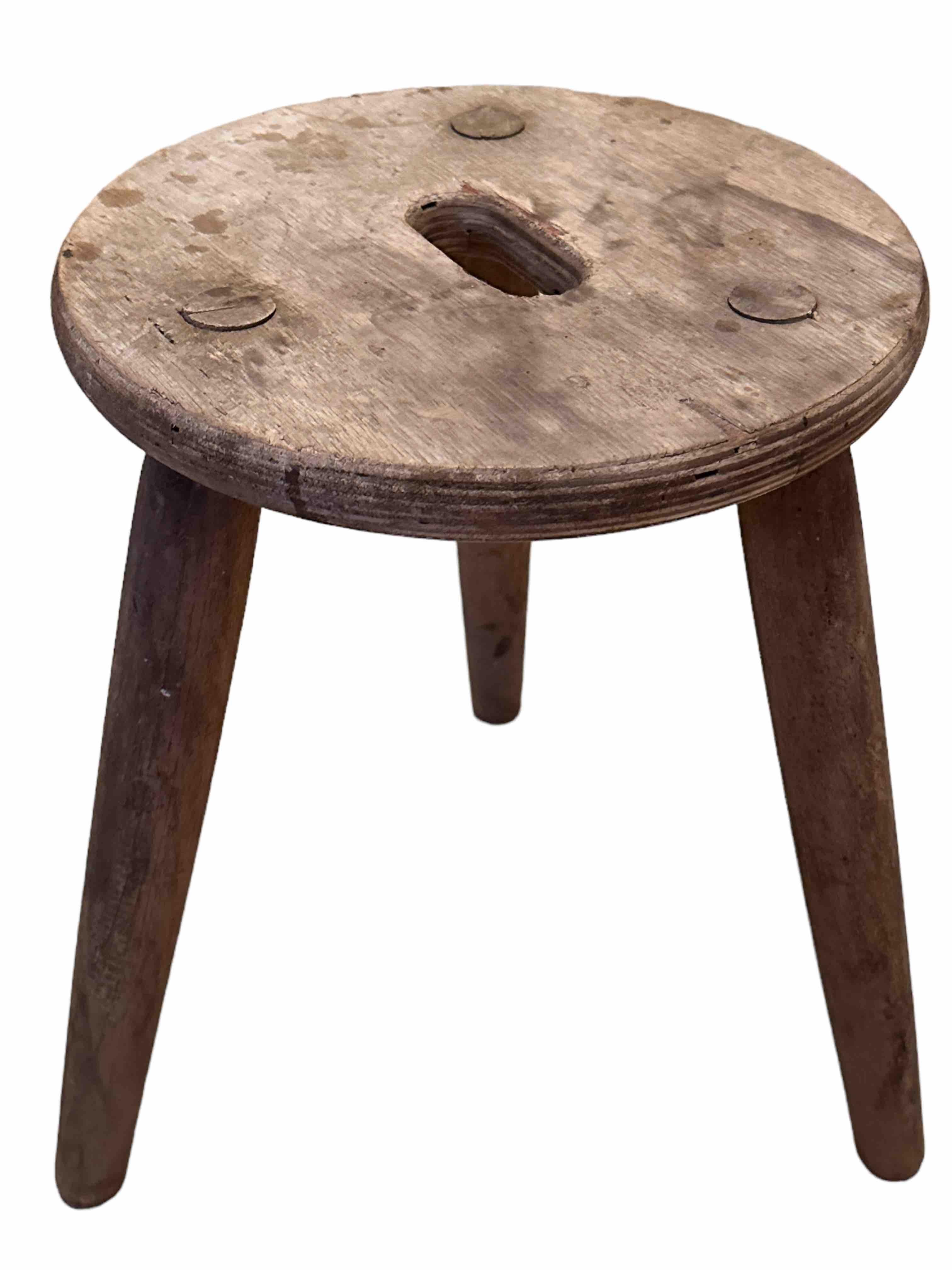 This 20th century wabi sabi 3 leg milking stool from Austria is an excellent example of this style. The piece has a round, rustic-looking seat made of wooden planks and is supported by three spindle legs. The stool has a simple, understated design