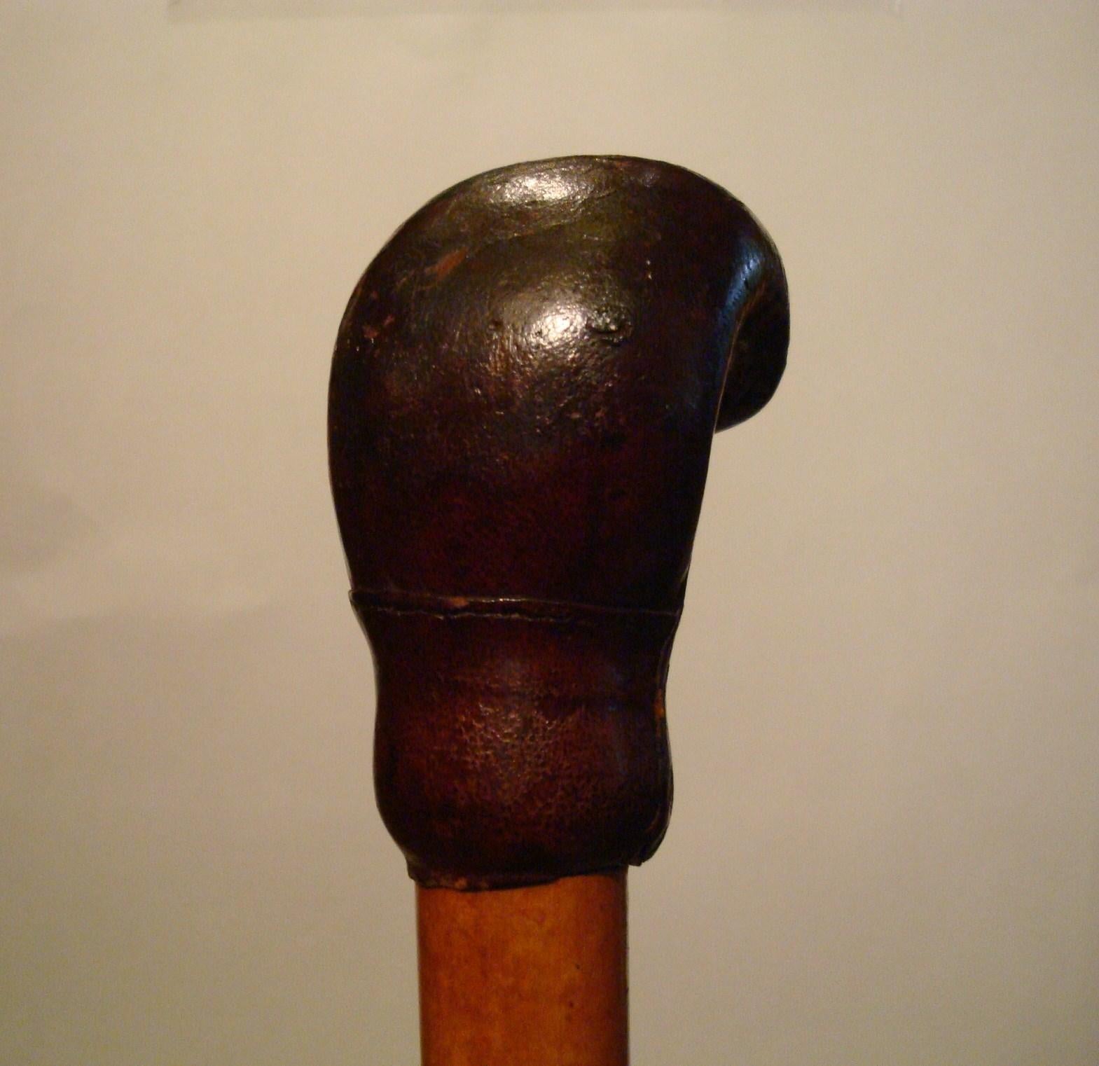 20th century walking stick, cane with leather boxing glove shape handle.
Rare boxing memorabilia. 
 