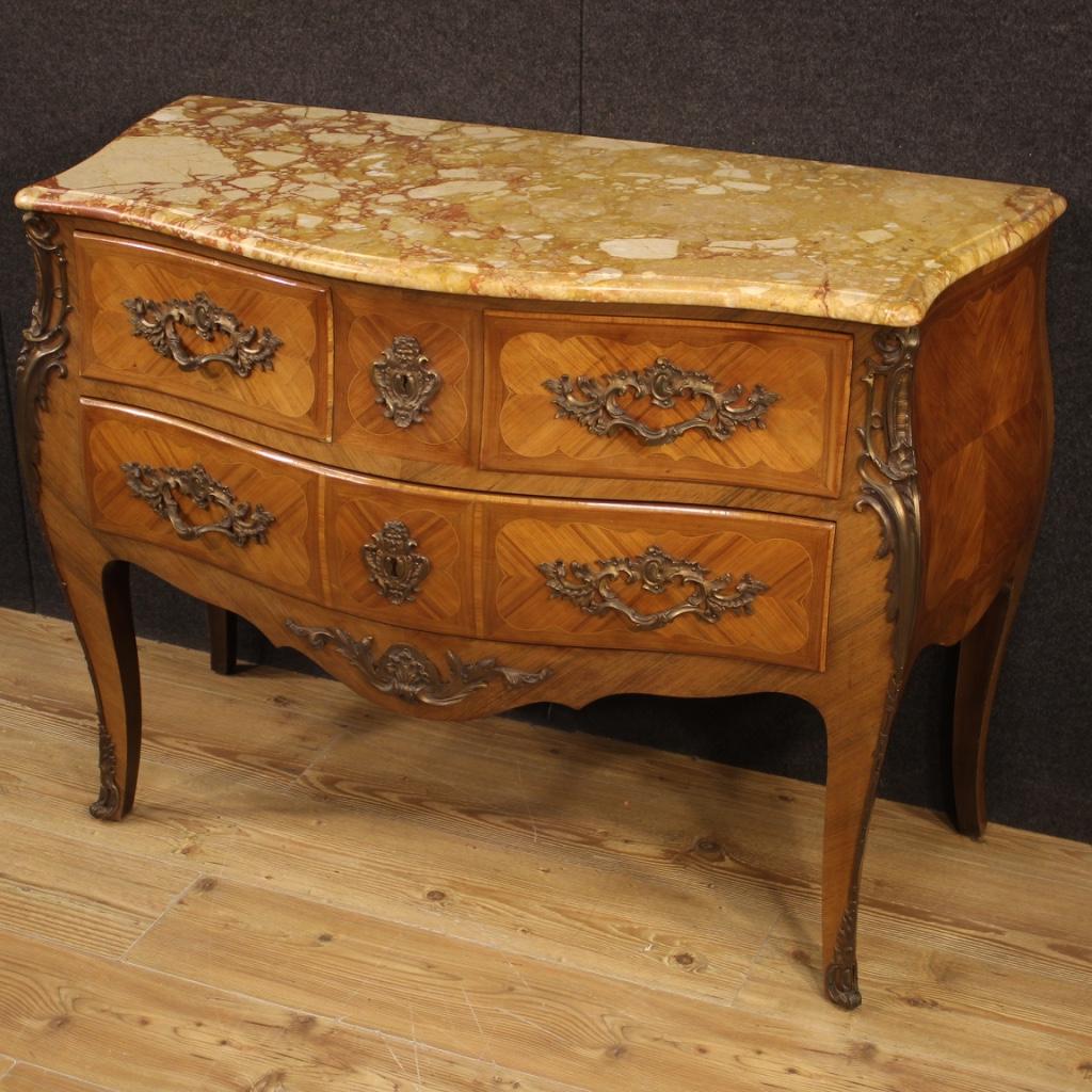 French dresser from the mid-20th century. Moved and rounded furniture in Louis XV style inlaid in walnut and boxwood and richly adorned with gilded and chiseled bronze. High quality chest of drawers with original marble top of good size and service.