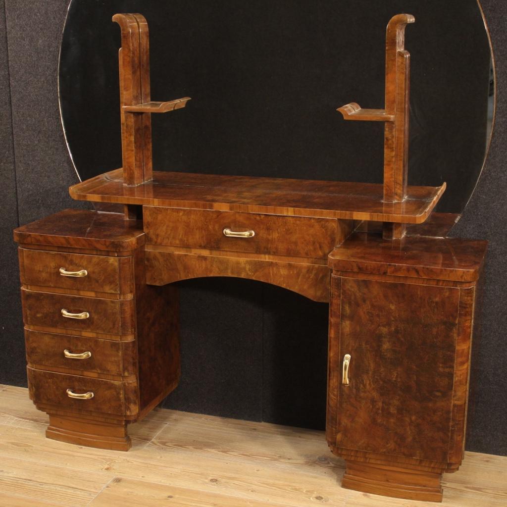 Italian dressing table from the mid-20th century. Fabulous furniture in walnut and burl wood with brass and bakelite handles. Furniture that supports a large half-moon mirror at the top, without breakage or chipping. Dressing table equipped with 5