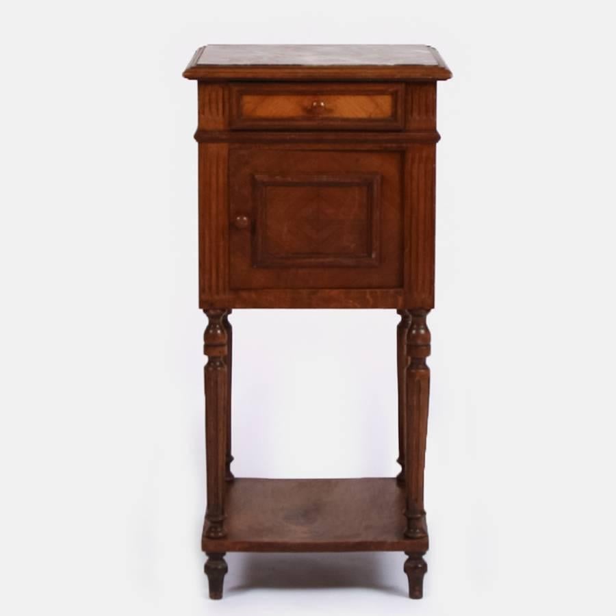 A lovely 20th century French walnut bedside cabinet with a pink veined marble top.