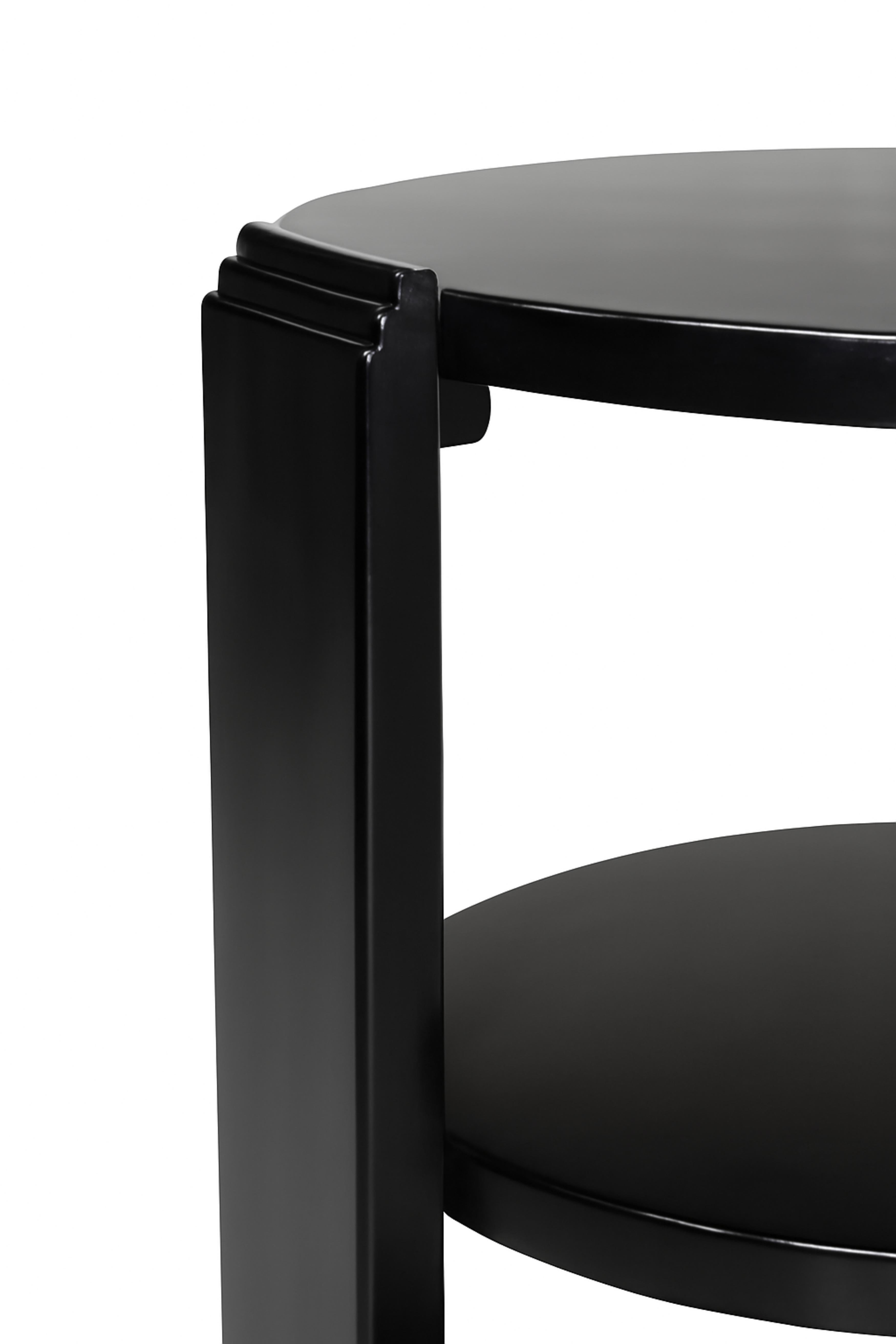 A french Art Deco two levels Black Lacquer round center table of inlaid walnut and a beautiful center, three legs and a circular base.

