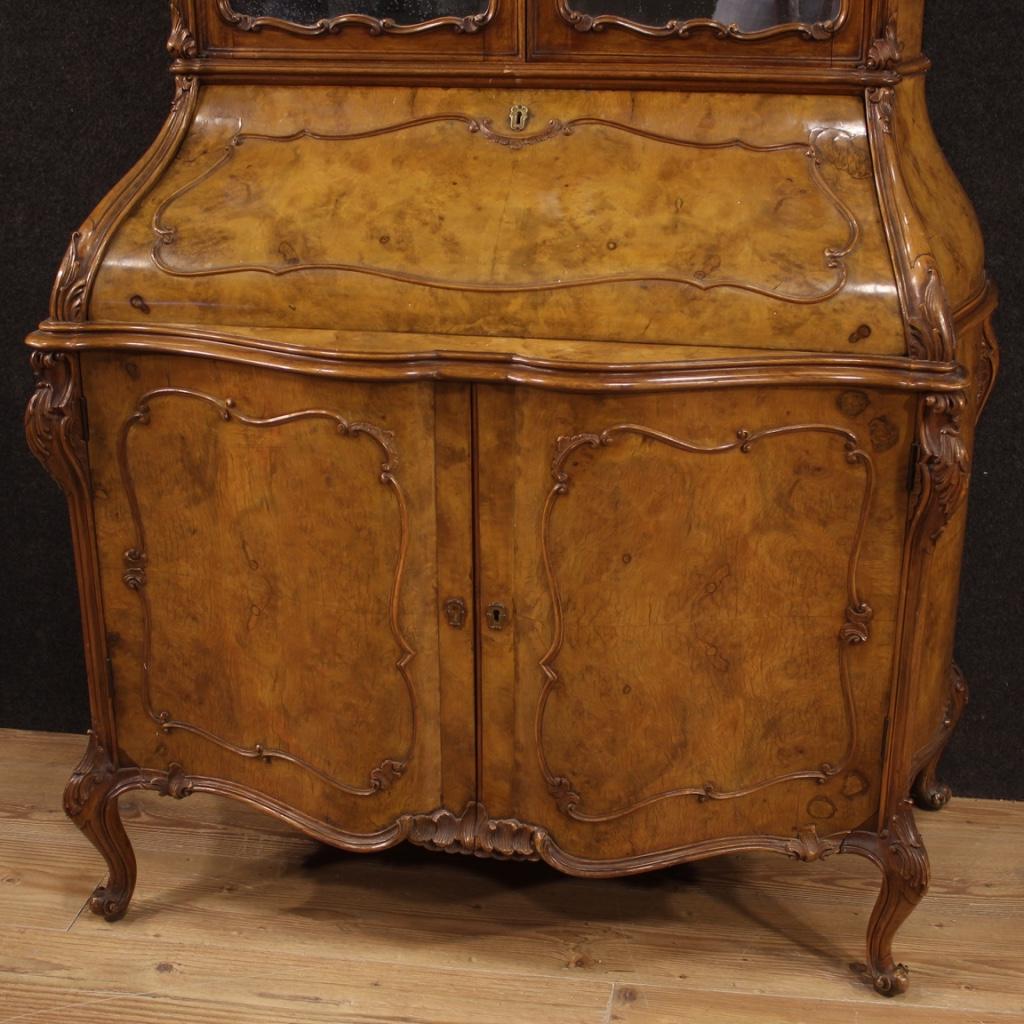 Lombard trumeau of the mid-20th century. Moved and rounded, double body, richly carved in walnut, burl and beech woods of beautiful lines and pleasant decor. Trumeau with a working key. Lower body with two doors and fall-front. Interior of the