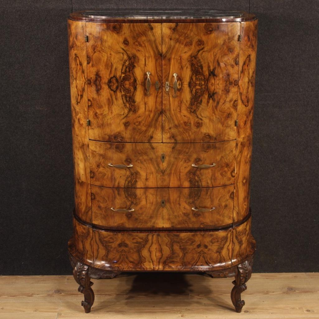 Italian secrétaire from the first half of the 20th century. Furniture of particular shape and construction sculpted and veneered in walnut, walnut burl, palisander and fruitwood. Secrétaire equipped with three large external drawers and two doors.