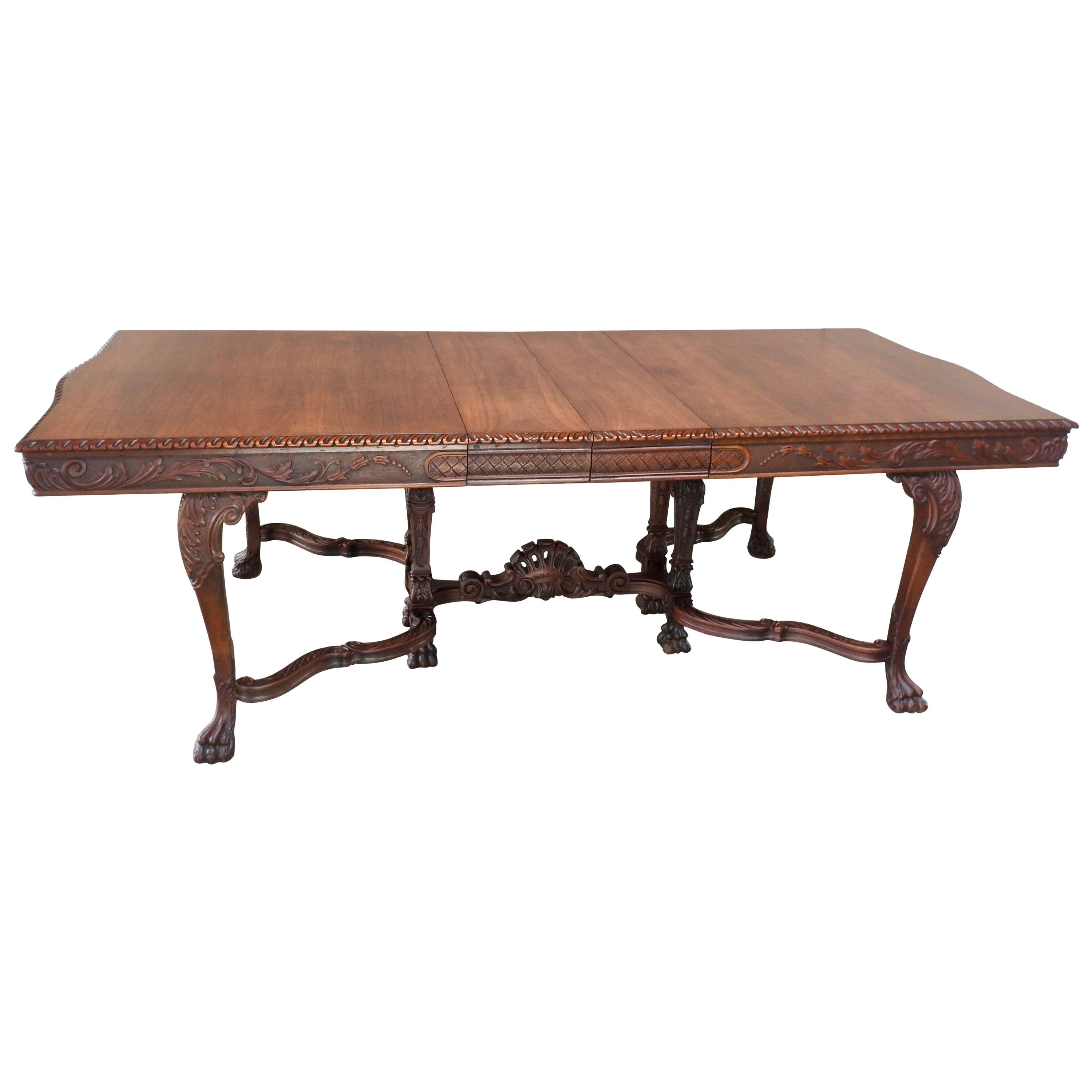 The details on this Victorian walnut dining table are exquisite! The draped carved legs have an ornate fan gracing the center. These are framed by the hairy paw feet. Scrolls and basketweave surround the edges of the table with curves on the ends.