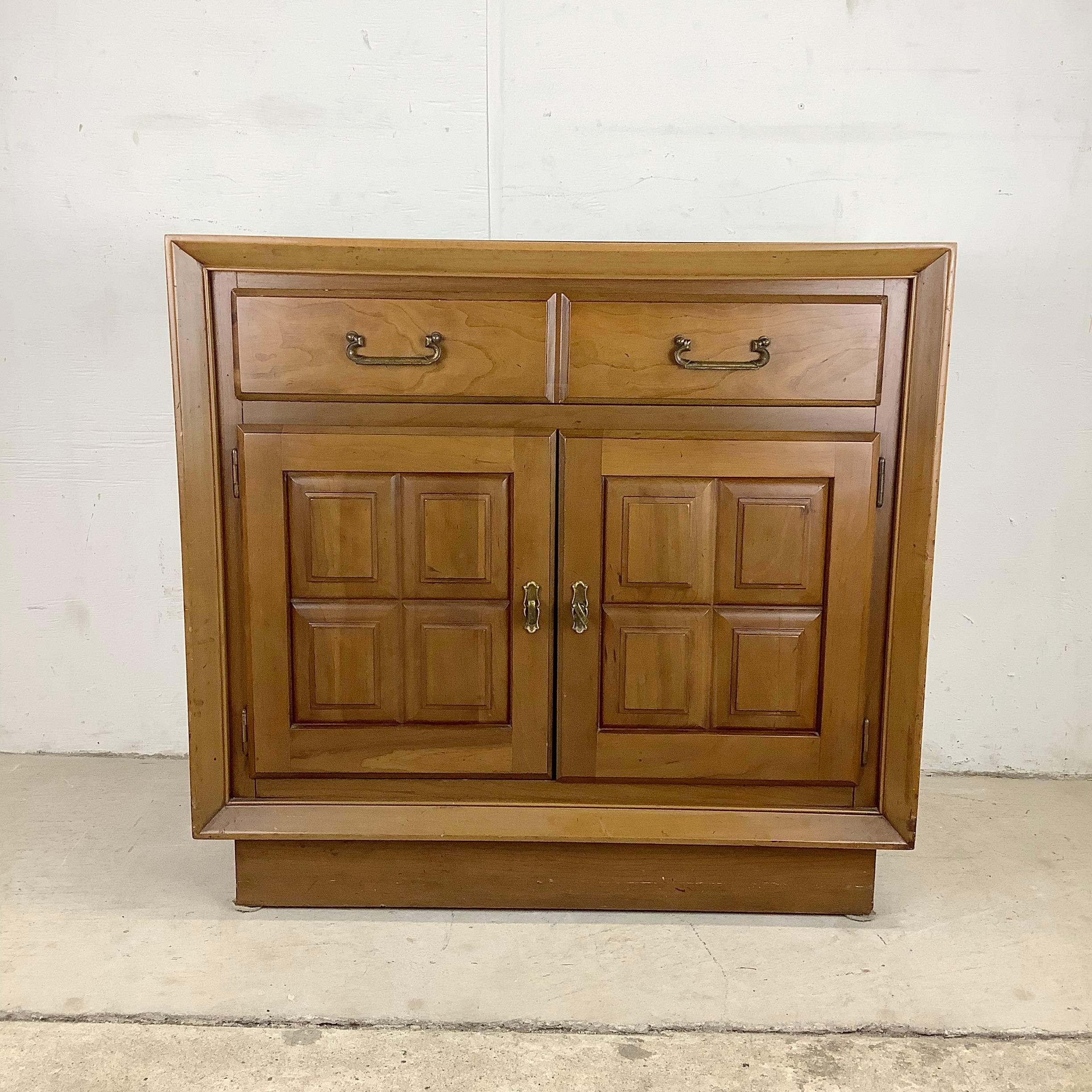 This vintage walnut storage cabinet is a testament to quality midcentury craftsmanship and offers both functionality and beauty to enhance your living space.

Created by United Furniture, this cabinet showcases exquisite design and attention to