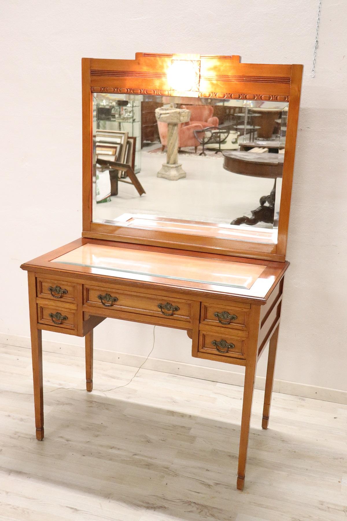 Beautiful particular solid walnut wood vanity table, 1930s. Characterized by refined simple line with elegant straight legs. Practical drawers. A light to use even in the dark. Perfect to be used in the bedroom for make-up. This piece of furniture