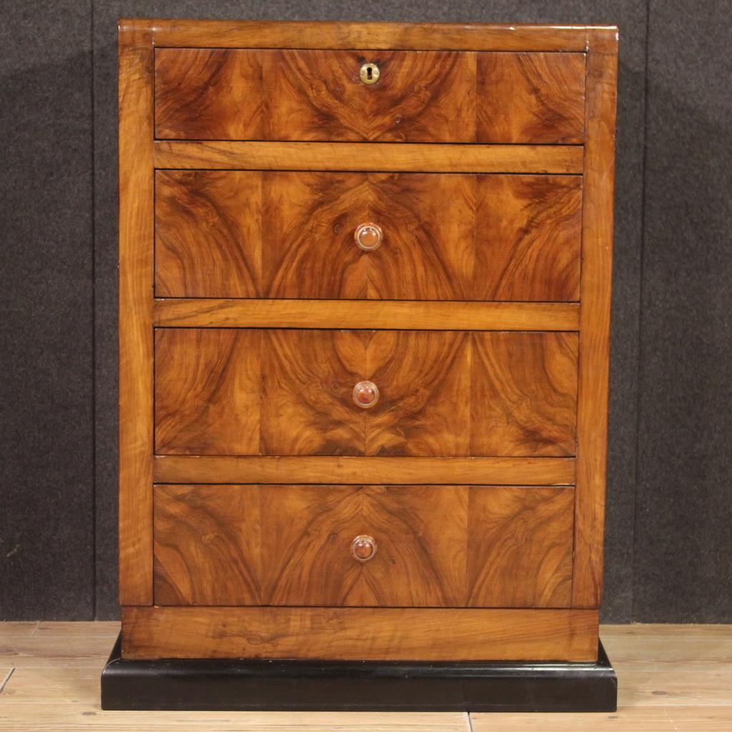 Elegant Italian chest of drawers from the mid-20th century. Art Deco style furniture with ebonized wooden base and body veneered in walnut wood, of excellent quality. Dresser equipped with four spacious drawers, the first of which, at the top, is