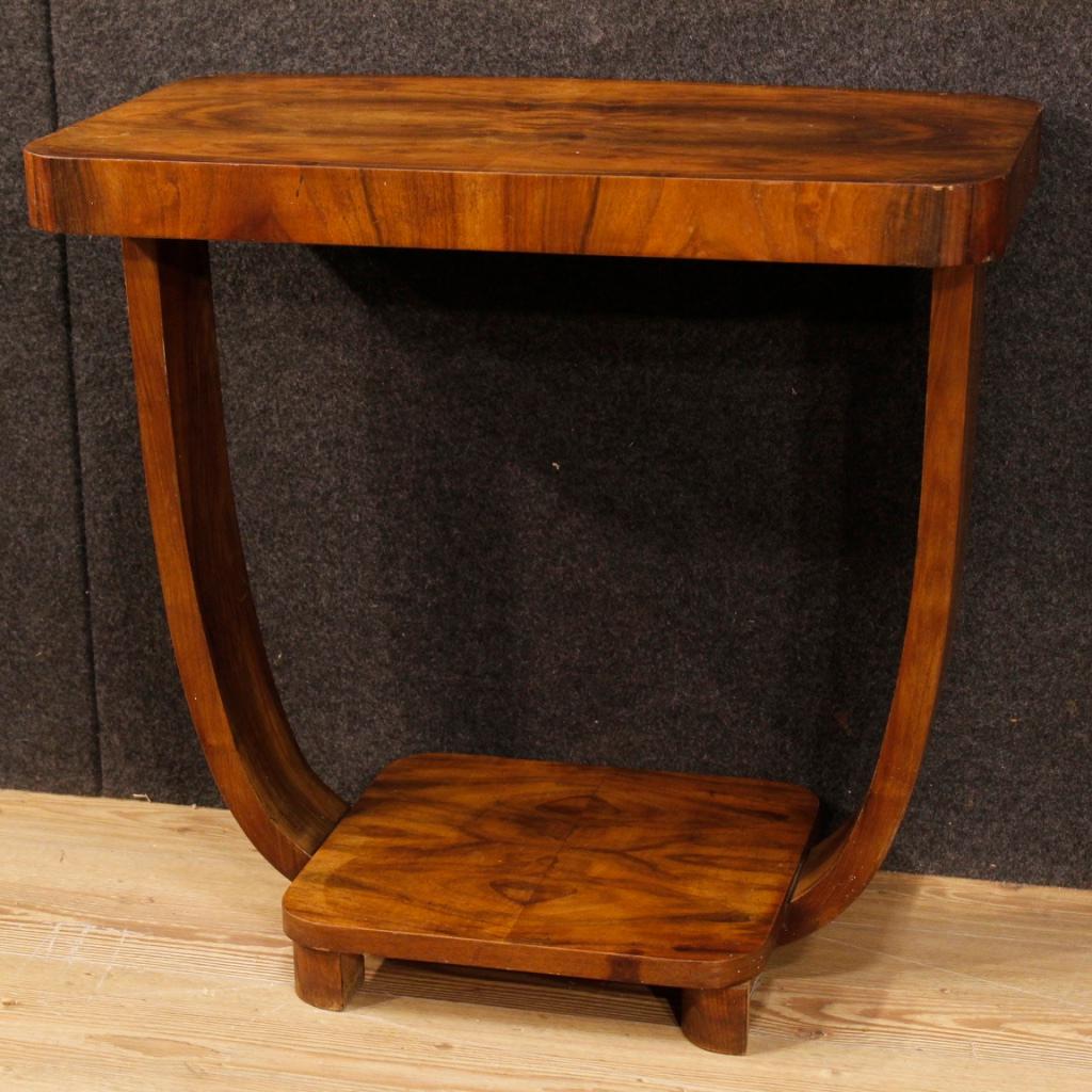 Italian side table from 20th century. Furniture in Art Deco style, veneered in walnut wood. Side table that can be easily placed into different parts of the home. Furniture with two shelves of good measure and service. It presents some signs of
