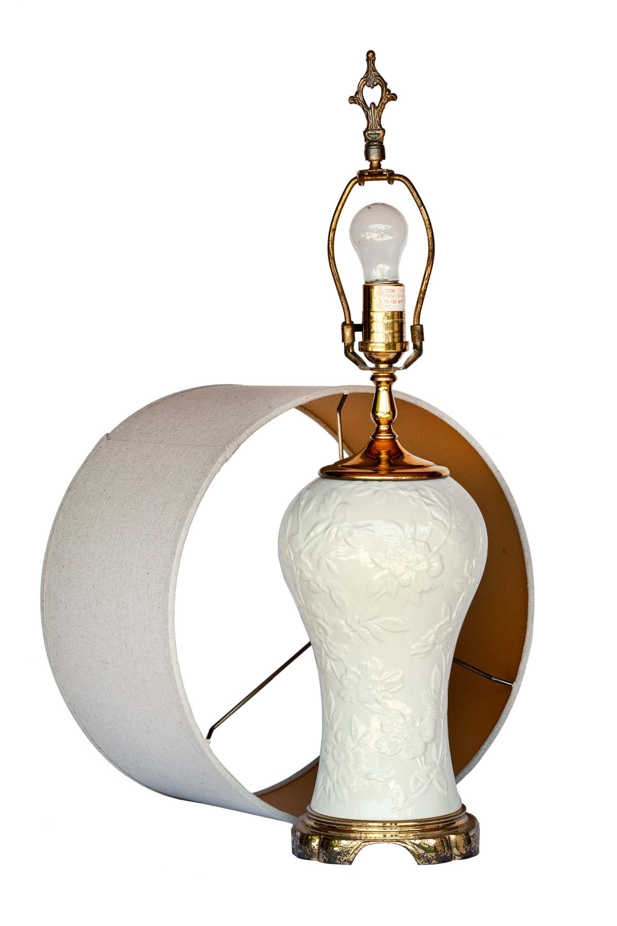 Waterford Blanc de Chine ginger jar lamp on a simple brass base. Lamp has an Asian flair. The linen shade is not included. 
Lovely brass finial.