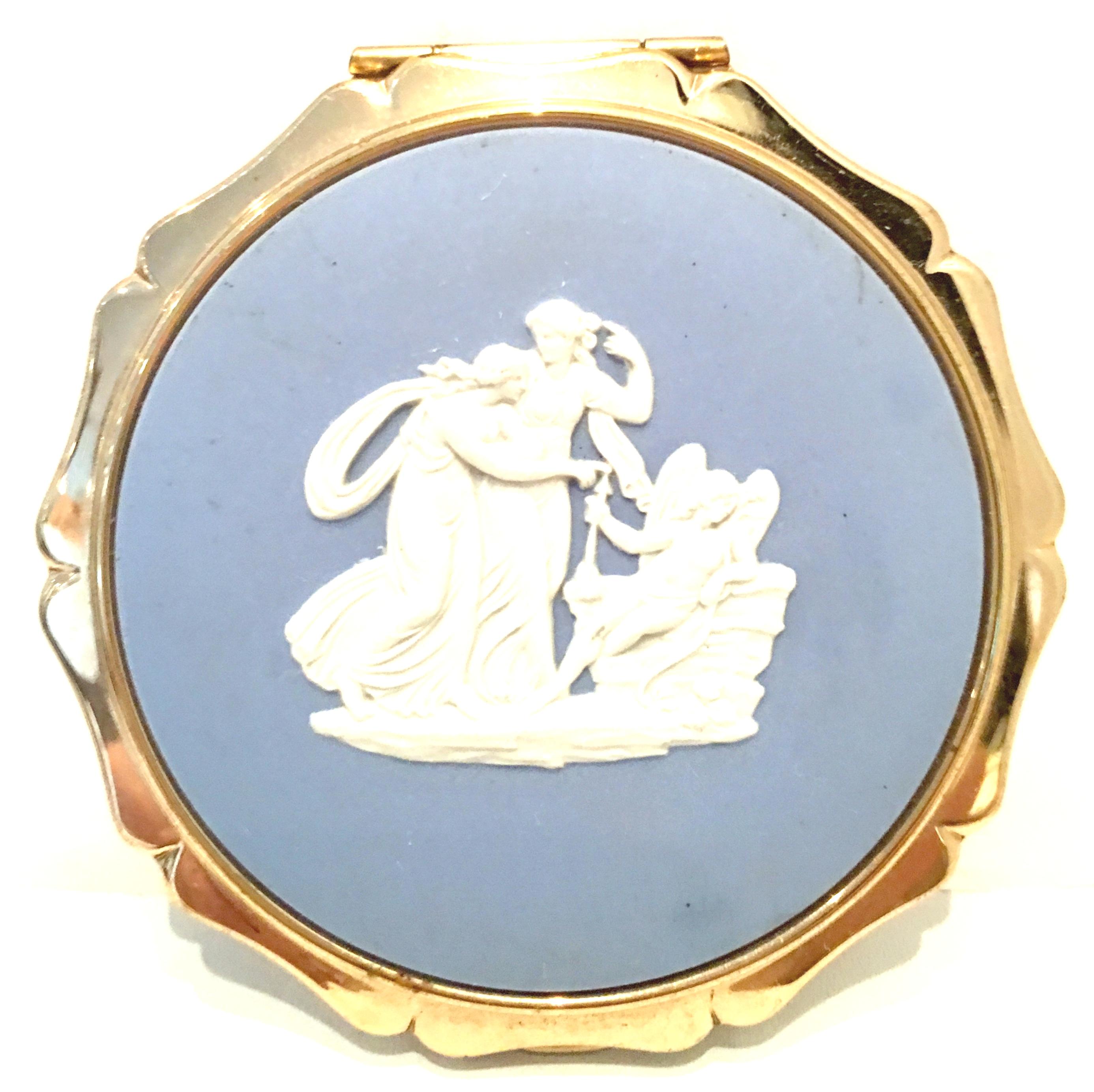 1960,S Wedgwood Jasperware & Gilt Bronze Mirrored Powder Compact by,  Stratton, England
This English blue authentic Jasperware Wedgwood insert with white high relief cherub motif features a gilt gold brass surround and detail. The interior contains