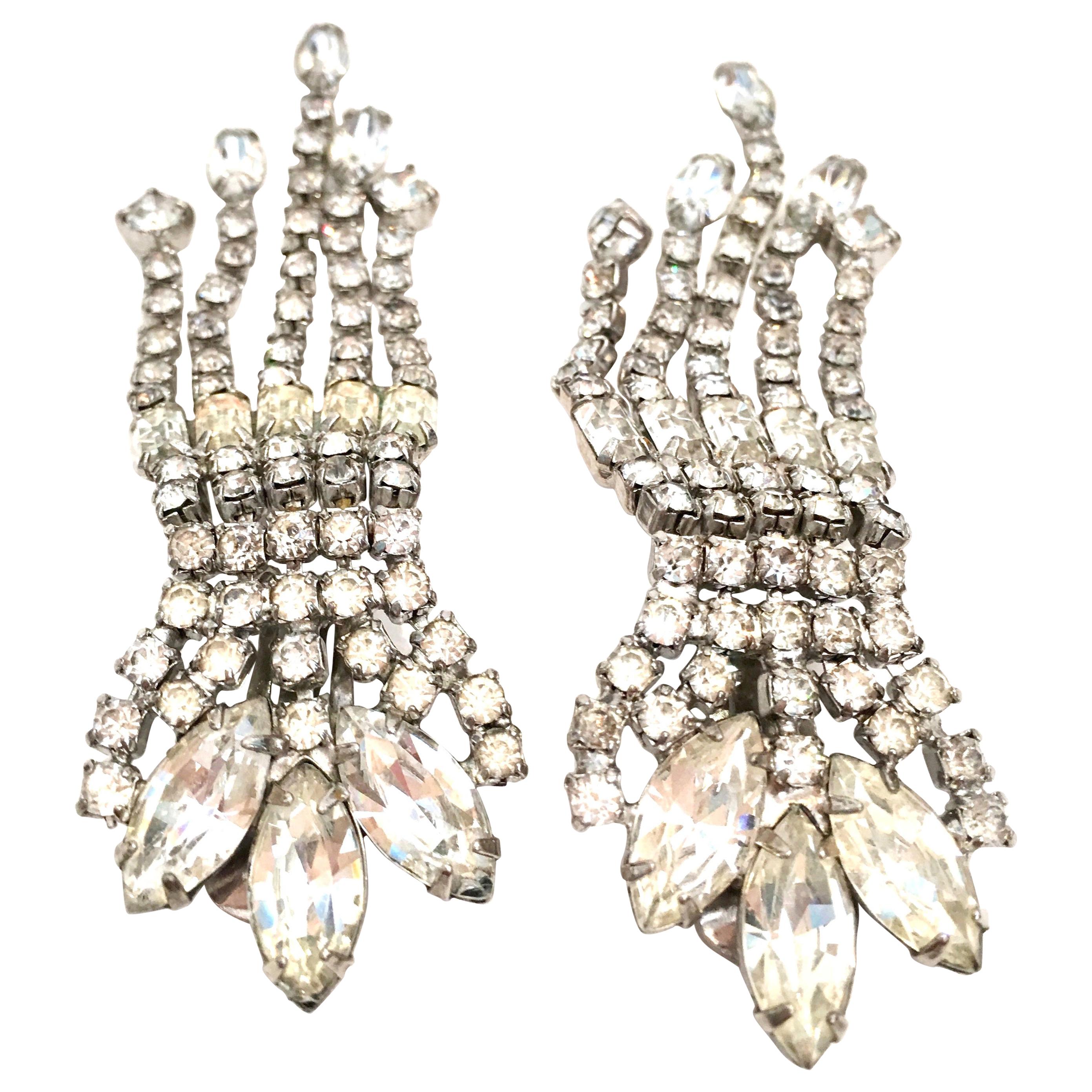 20th Century Weiss Style Silver & Swarovski Crystal chandelier earrings. These clip style earrings feature rhodium plate base metal with brilliant prong set cut and faceted pear, square, round and dramatic baguettes crystal clear stones.