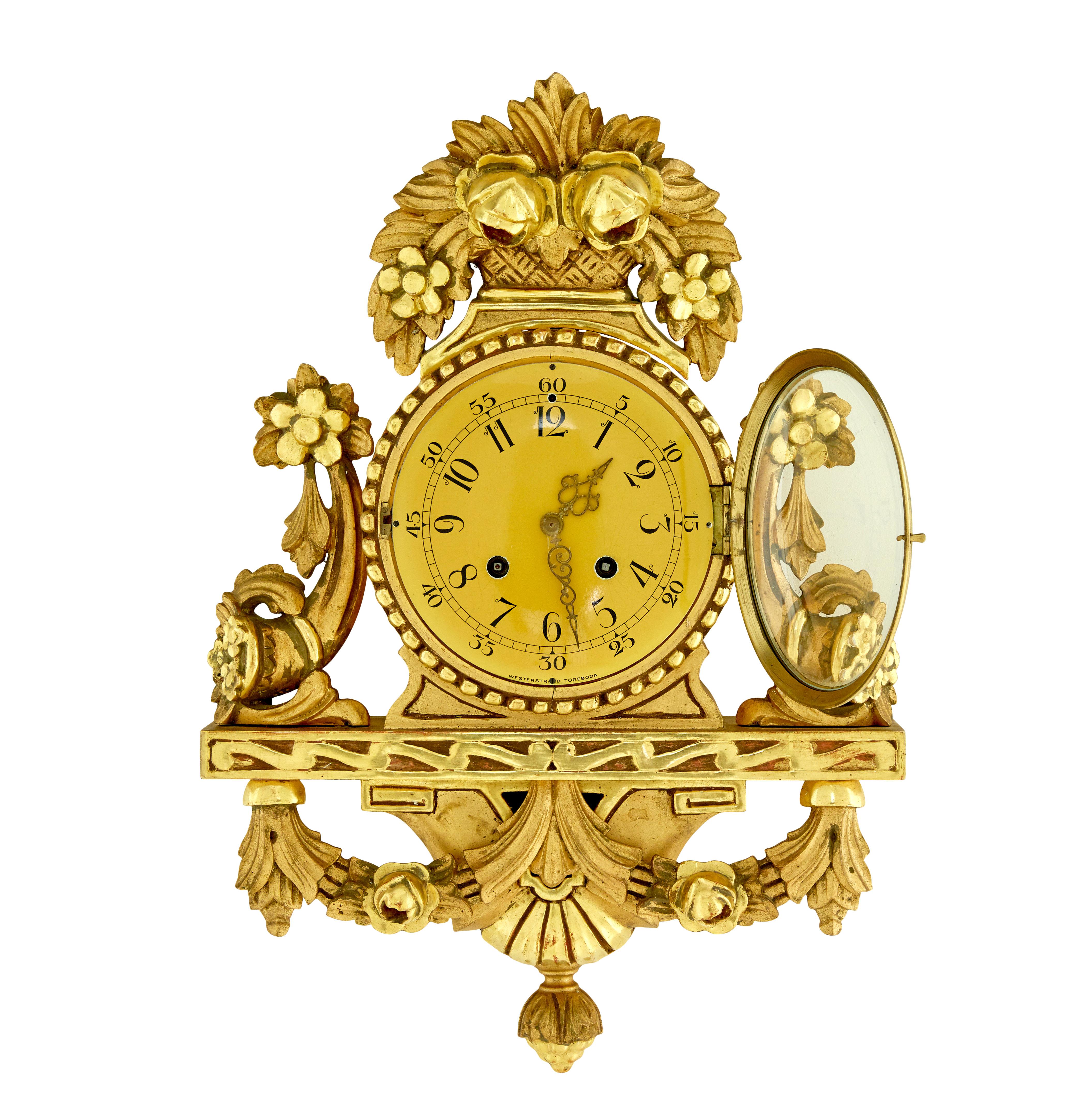 Good quality rococo influenced clock by well known Swedish maker Westerstrand.

Fitted with a twin train 8 day movement and original pendulum. Enamel clock face with arabic numerals and ornate pierced hands, central clock face surmounted with carved