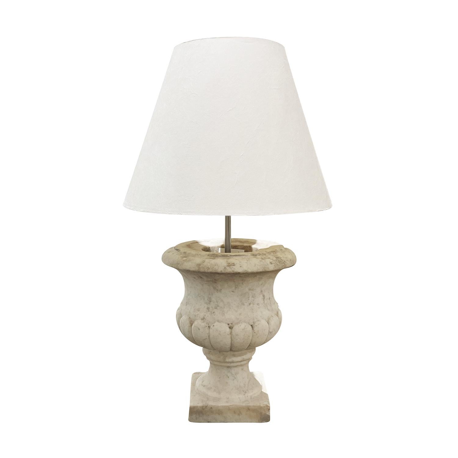 A vintage Mid-Century Italian table lamp made of hand crafted marble with the original shade and a single light socket. The marble bodice is in the shape of a garden urn. The wires have been renewed. Minor fading, due to age. Wear consistent with