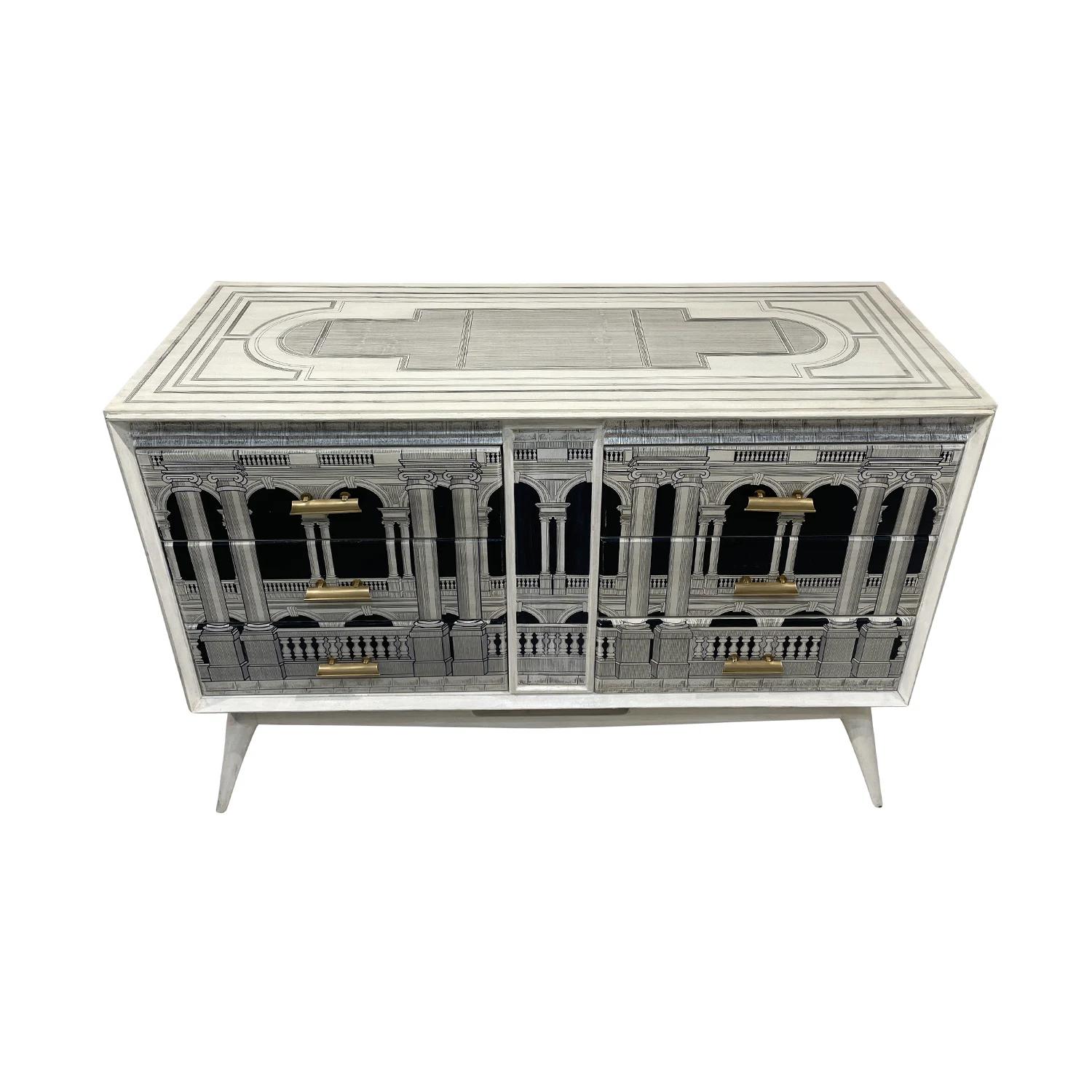 A white-black, vintage Mid-Century Modern Italian dresser, chest made of handcrafted lacquered, painted Walnut in the style of Piero Fornasetti in good condition. The front side of the commode is particularized with architectural renderings. The