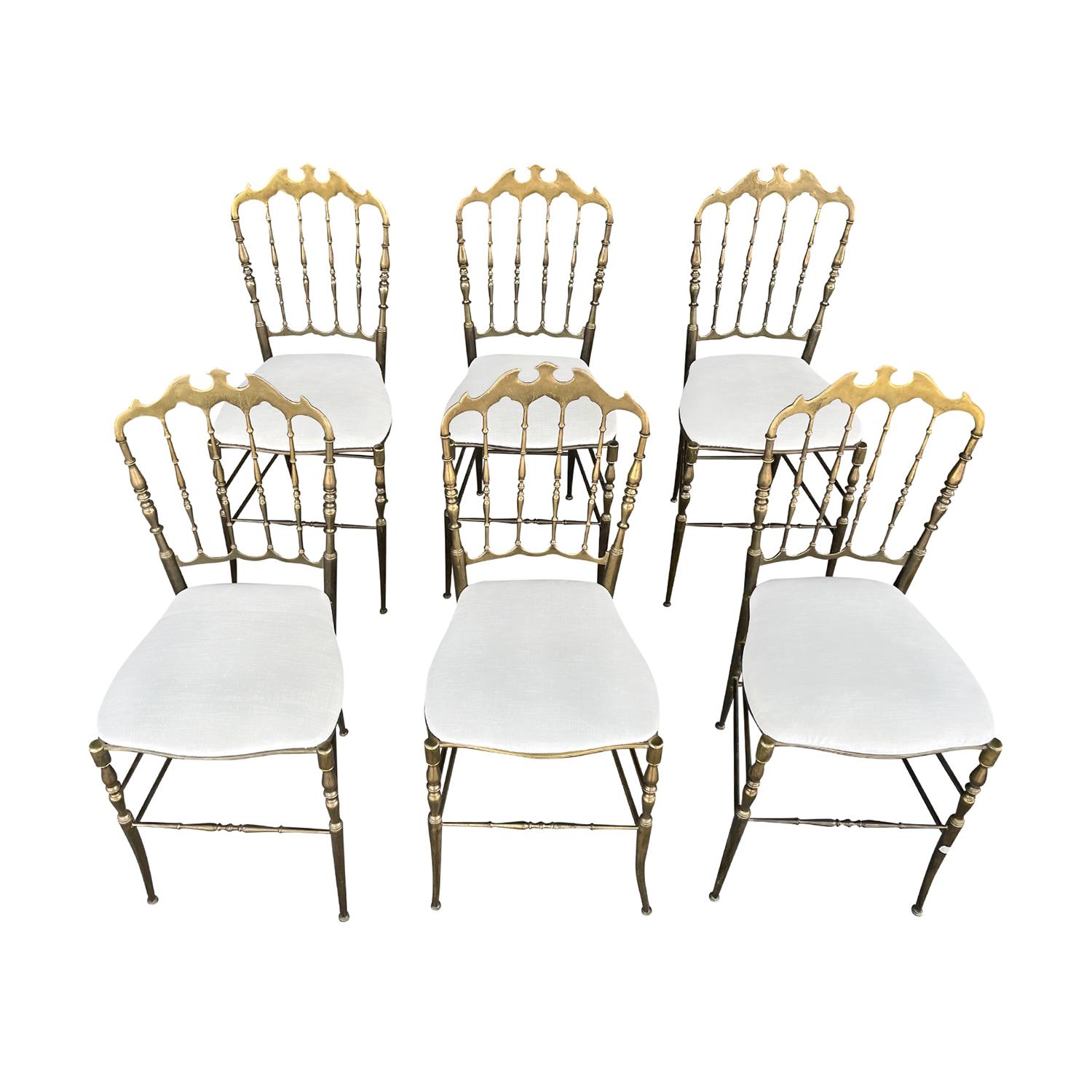 A vintage Art Deco Italian Modernist dining chairs made of hand crafted gilded brass, designed and produced in Chiavari in good condition. The legs of the small detailed side chairs are slightly splayed, connected with pairs of cross supports. Newly