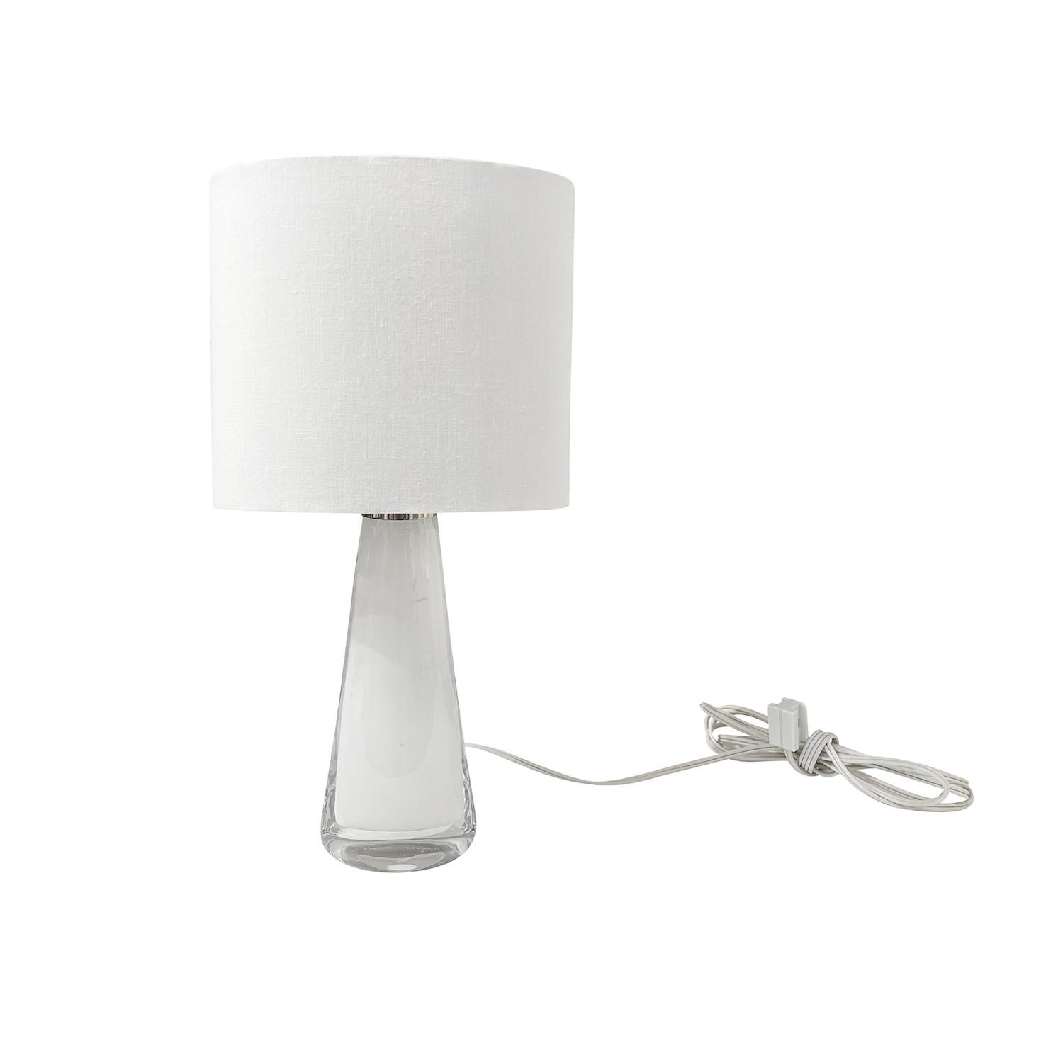 An oval shaped, vintage Art Deco Swedish table lamp with a new white oval shade, made of hand blown Orrefors glass, the beam is enhanced with a chrome ring and an antique, original looking light switch, featuring a one light socket in good