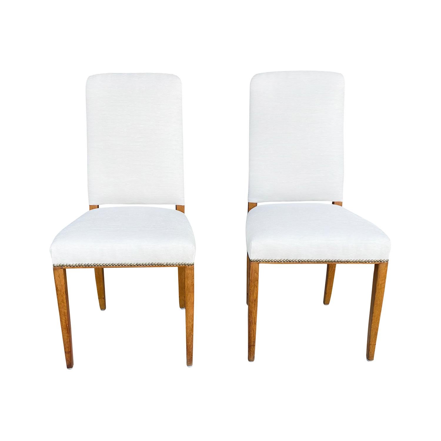 A vintage Mid-Century Modern Swedish pair of dining chairs made of hand crafted Birchwood, designed by Carl Malmsten and produced by Möbel Komponerad AV in good condition. The Scandinavian side, corner chairs are enhanced by detailed brass