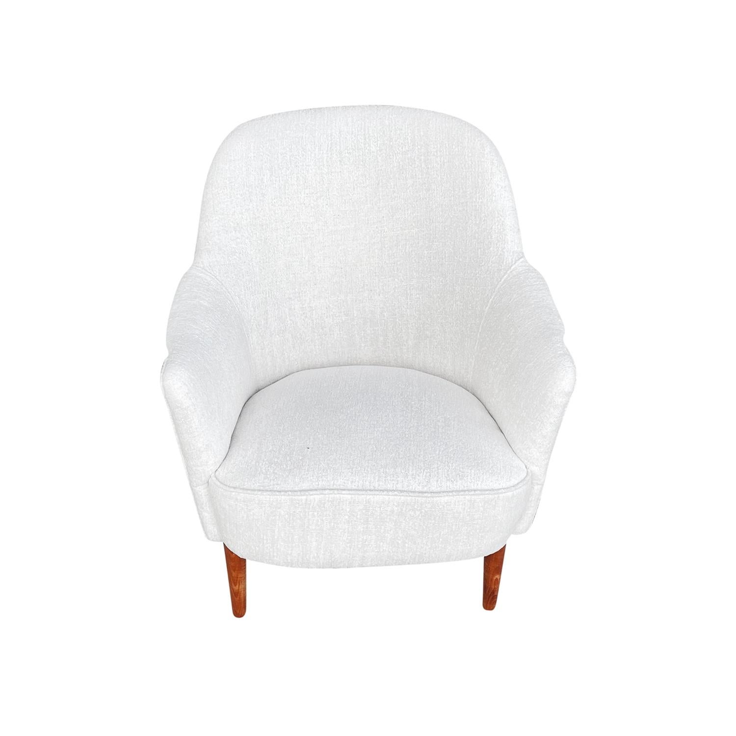 A small, vintage Mid-Century Modern Swedish Sample easy, lounge chair designed by Carl Malmsten in good condition. The Scandinavian armchair is standing on four slightly curved Birchwood feet. Newly upholstered in a white cotton fabric. Wear