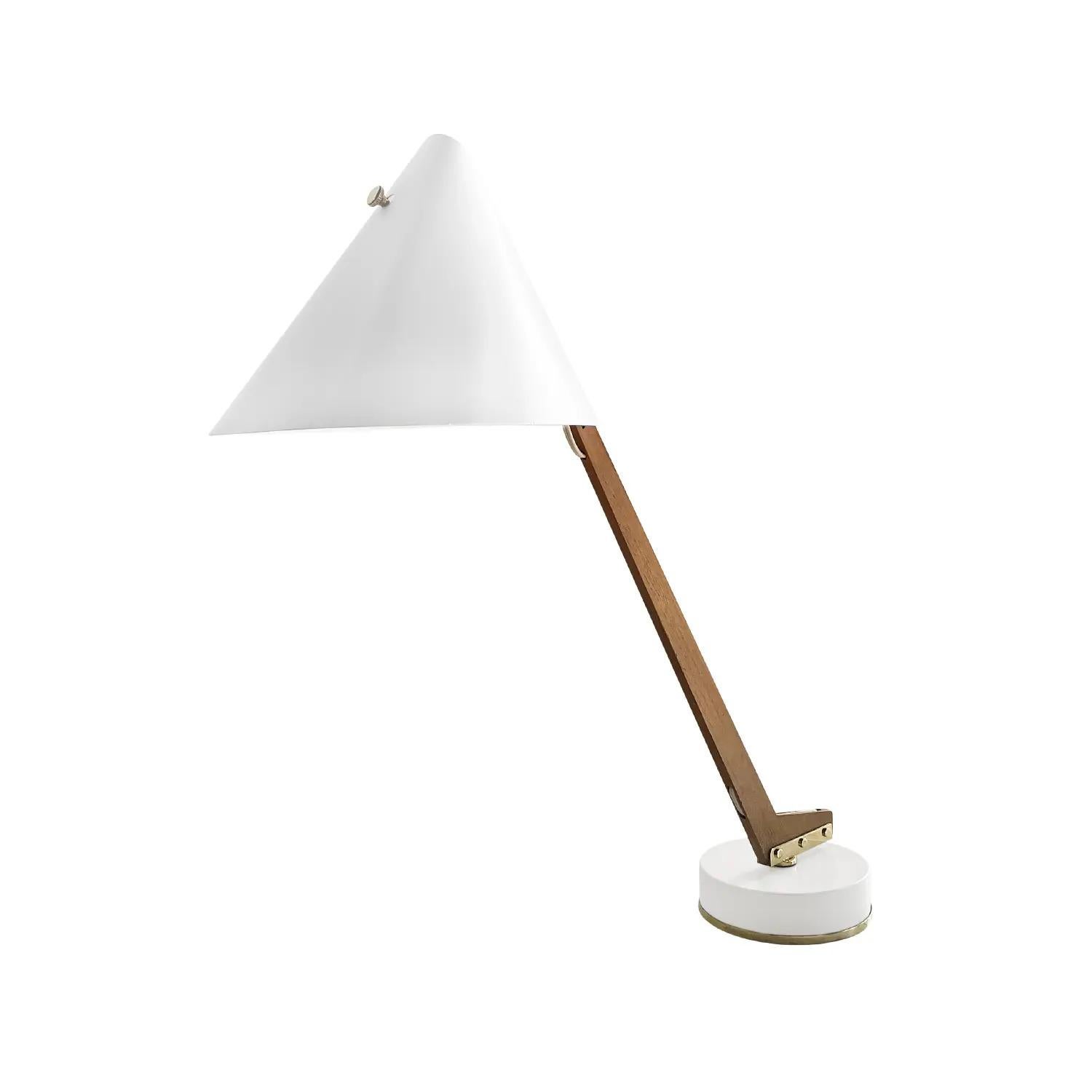 A vintage Mid-Century Modern Swedish table lamp made of hand carved Teakwood, designed by Hans-Agne Jakobsson and produced by AB Markaryd in good condition. The stem of the Scandinavian desk light is flexible , adjustable attached to the round white