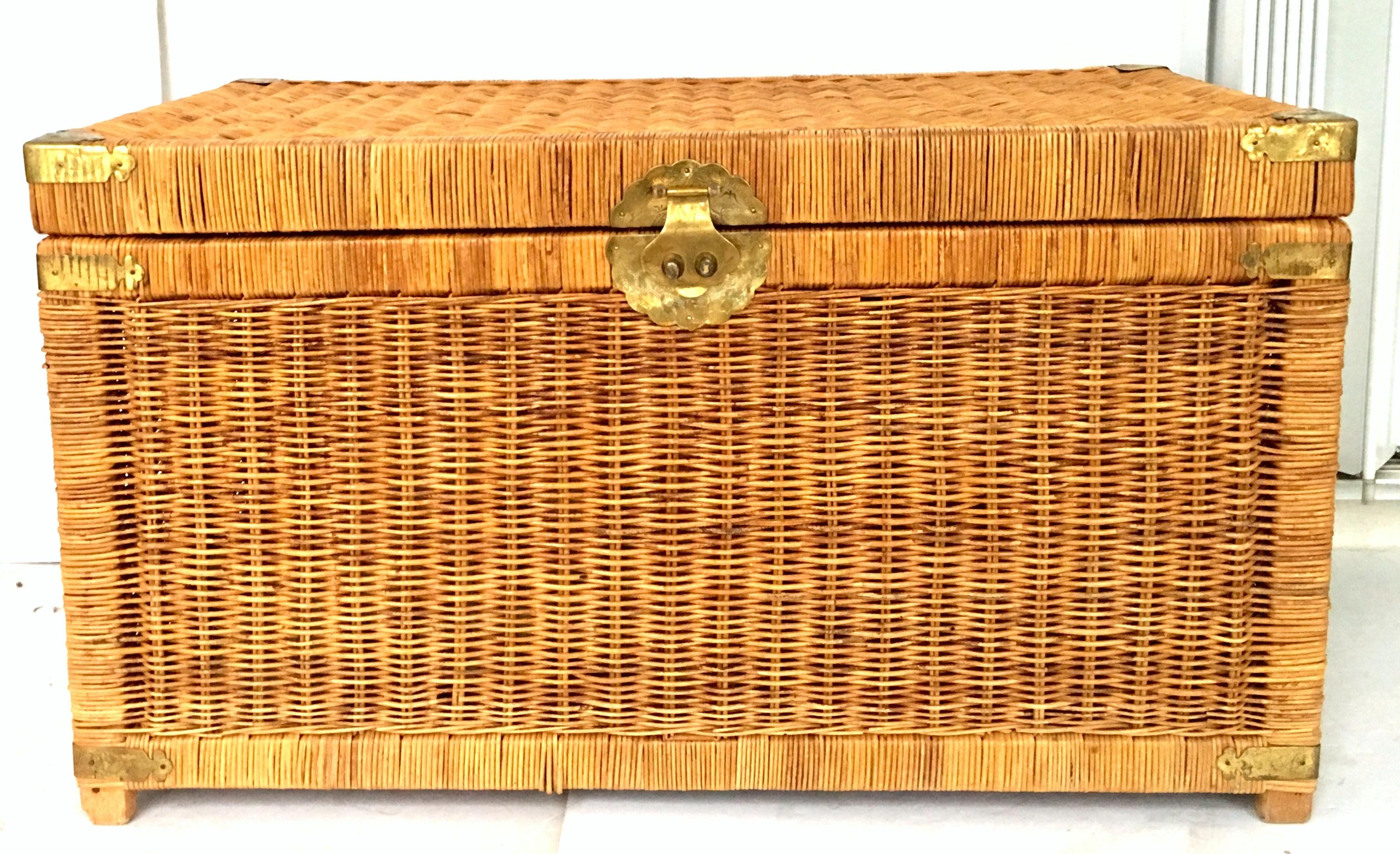 20th Century large-scale wicker and Asian style brass storage trunk chest. Features raised wood feet and etched Asian motif hardware. The top is hinged for easy access and storage.
A glass top added would make this a great multi purpose table.
 
