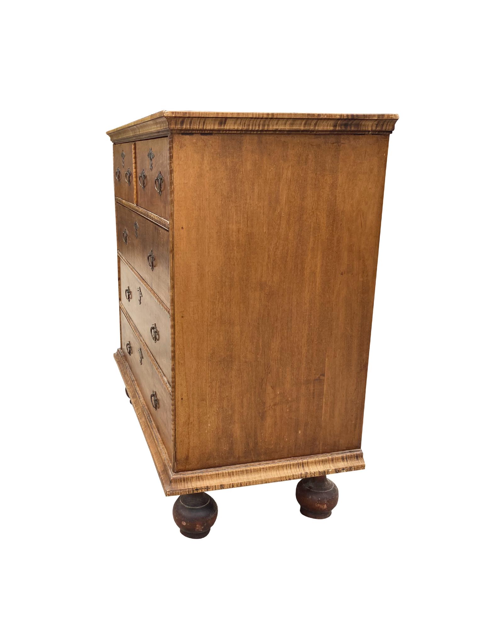 This refined flat-top chest is designed in the classic William & Mary style. It is attributed to craftsman Bill Roth, who created antique replicas faithful to traditional design. The chest is comprised of a tiger maple case with 4 drawers. Its top