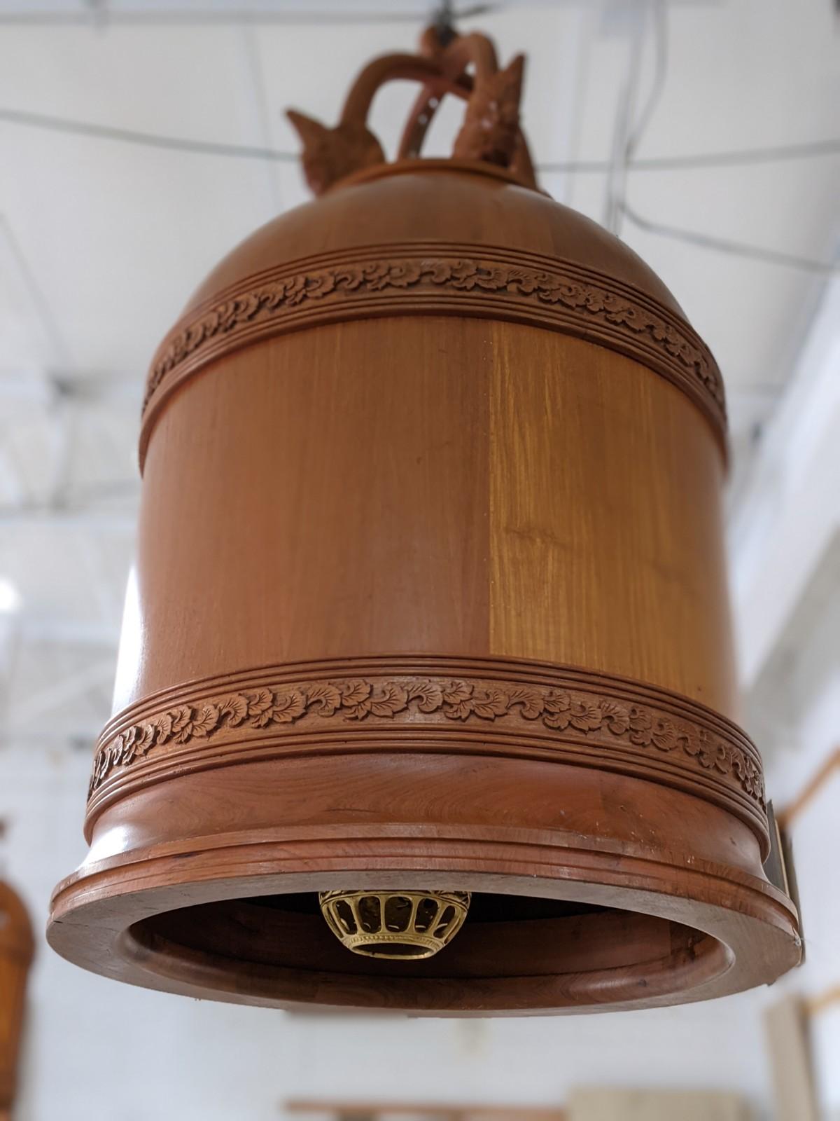 This wood lamp with bronze interior origins from France, circa 1970.