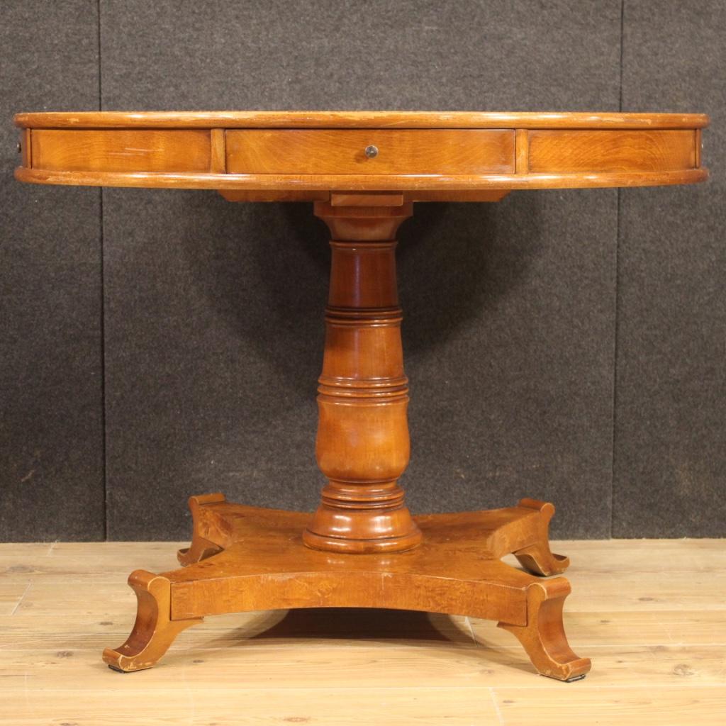 French table from 20th century. Furniture veneered in mahogany, burl, beech and fruitwood of beautiful lines and pleasant decor. Living room table with central leg equipped with 4 side drawers (see photo). Furniture of good solidity and stability