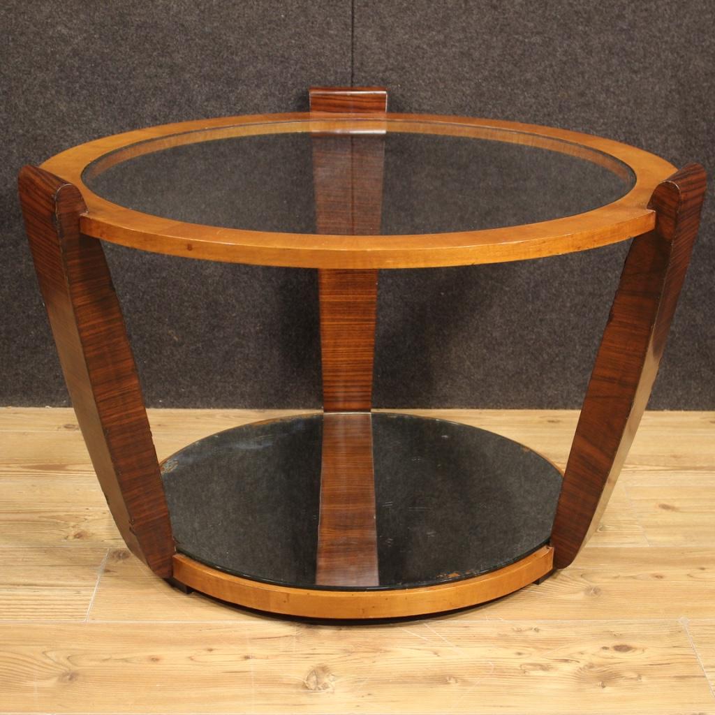Italian design coffee table from the 60s / 70s. Nice line furniture of pleasant decor in palisander and cherry wood with double shelves. Recessed glass top with several scratches and signs of wear. Lower shelf with mirrored glass which also has this