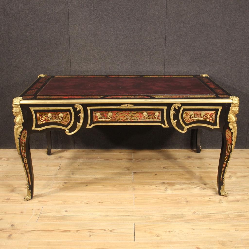 French writing desk from 20th century. Napoleon III Boulle style furniture in ebonized wood and faux tortoise with brass and chiseled and gilded bronze of good quality. Desk finished for the center, equipped with three front drawers of good