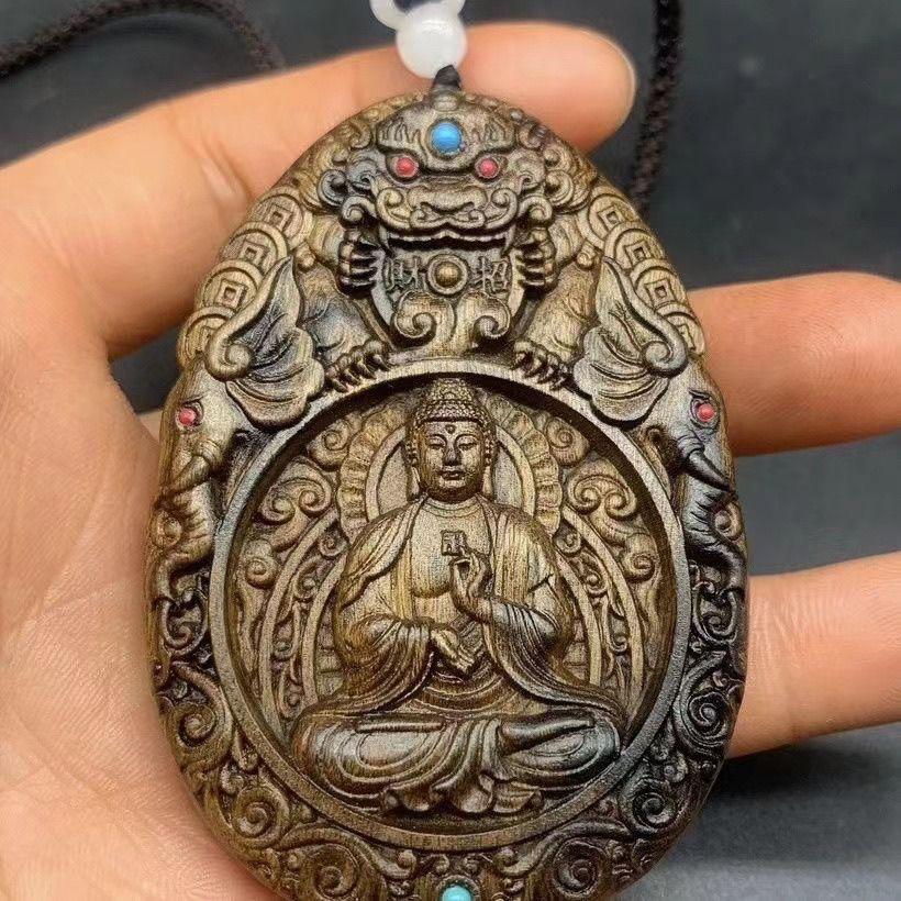 This 20th Century Wood Carved Pendant features the Great Amitabha Buddha, revered as a Zodiac Guardian Deity in East Asian Buddhist tradition. Hand-carved from natural hardwood, the pendant displays a serene and compassionate expression of Amitabha,