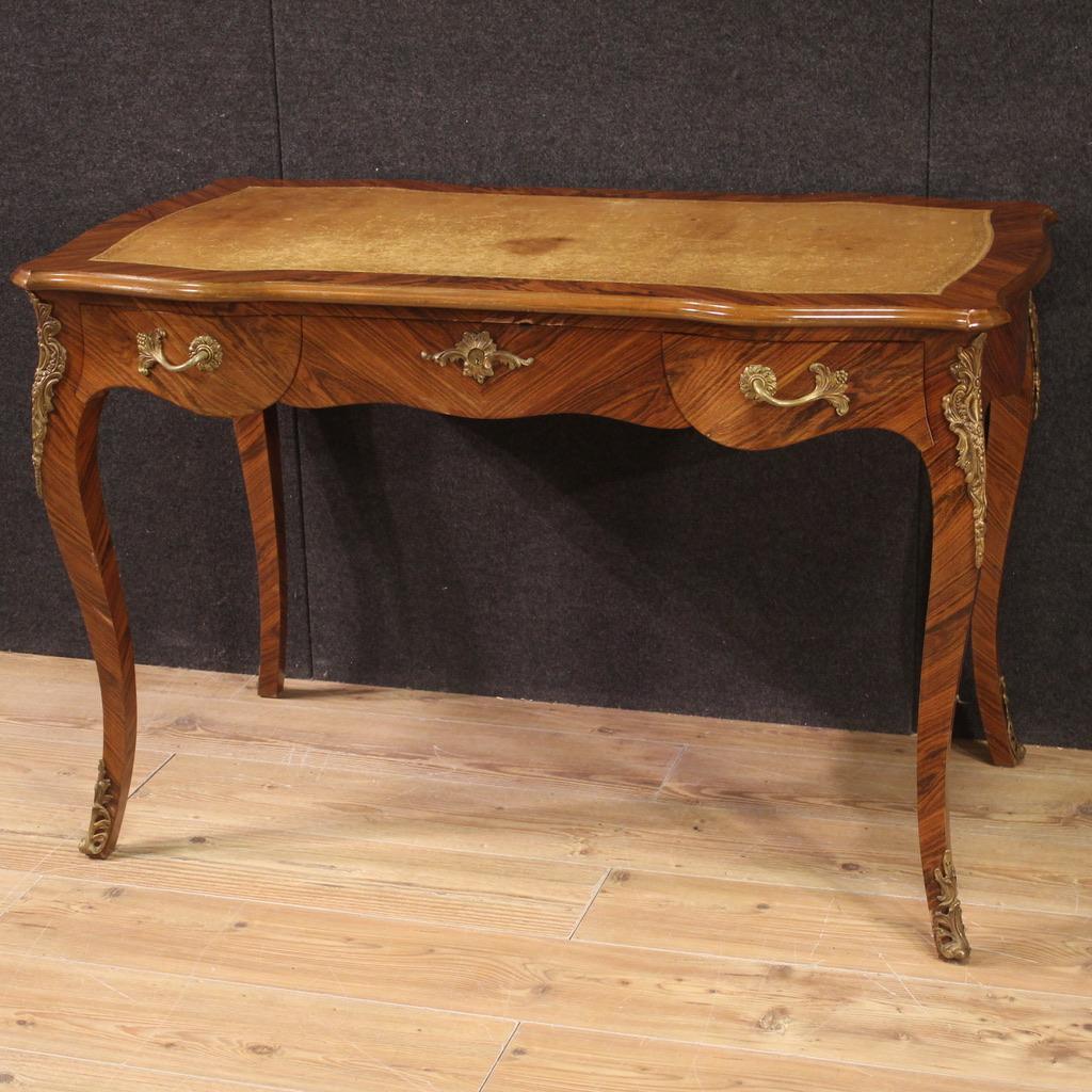French writing desk from the second half of the 20th century. Louis XV style furniture veneered and carved in walnut and palisander, with beautiful lines and pleasant decor. Finished desk from the center, equipped with three front drawers of good