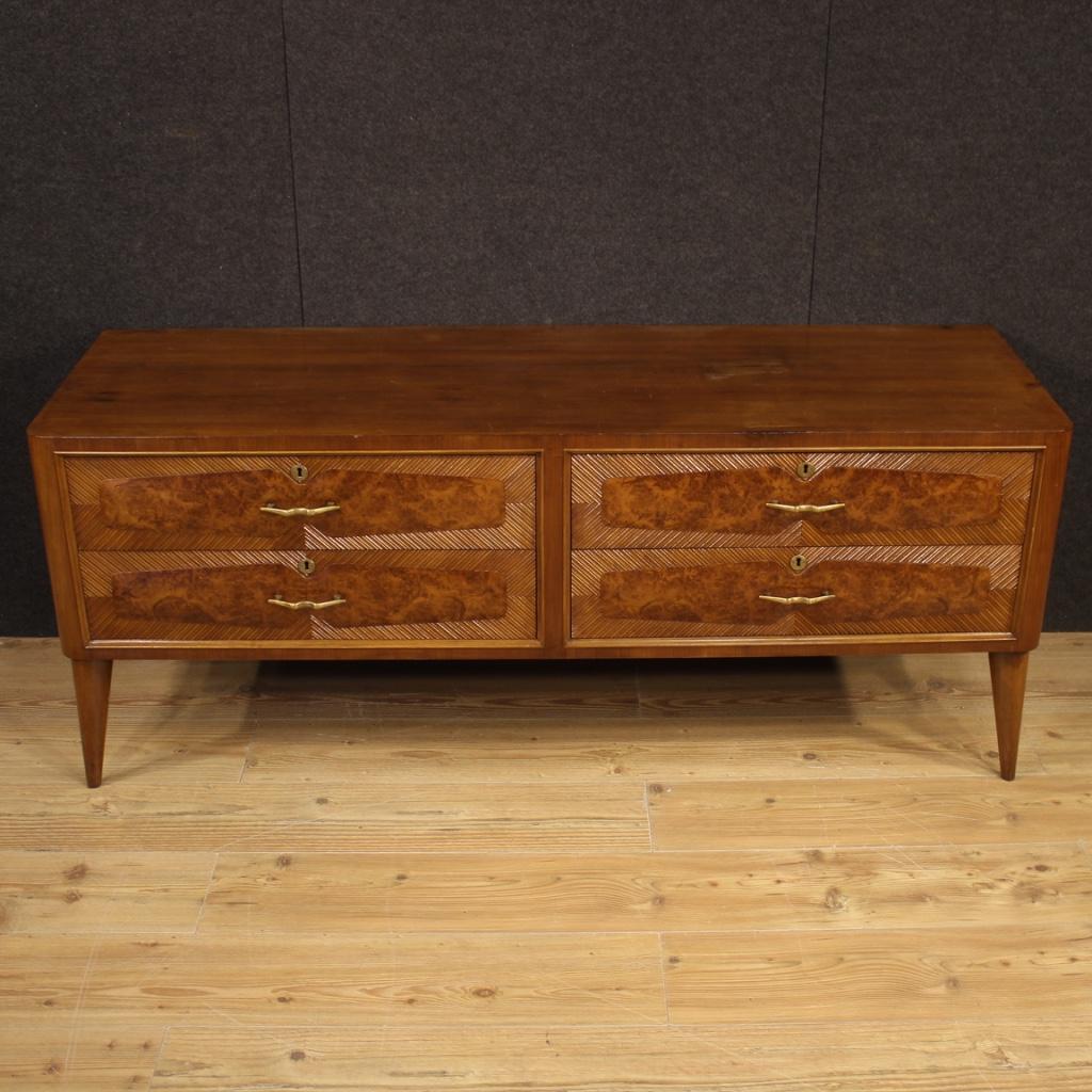 Low chest of drawers of Italian design from the 1960s-1970s. Beautiful dresser carved in walnut, burl, beech and fruitwood. Furniture of particular construction, equipped with four drawers of excellent capacity with golden brass handles. Without
