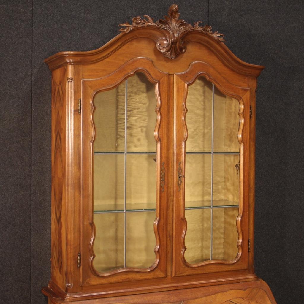 Italian trumeau from the mid 20th century. Double body display cabinet carved and veneered in walnut, mahogany, rosewood and beech of beautiful lines and pleasant decor. Lower body equipped with two large drawers and fall-front. Inside of the bureau